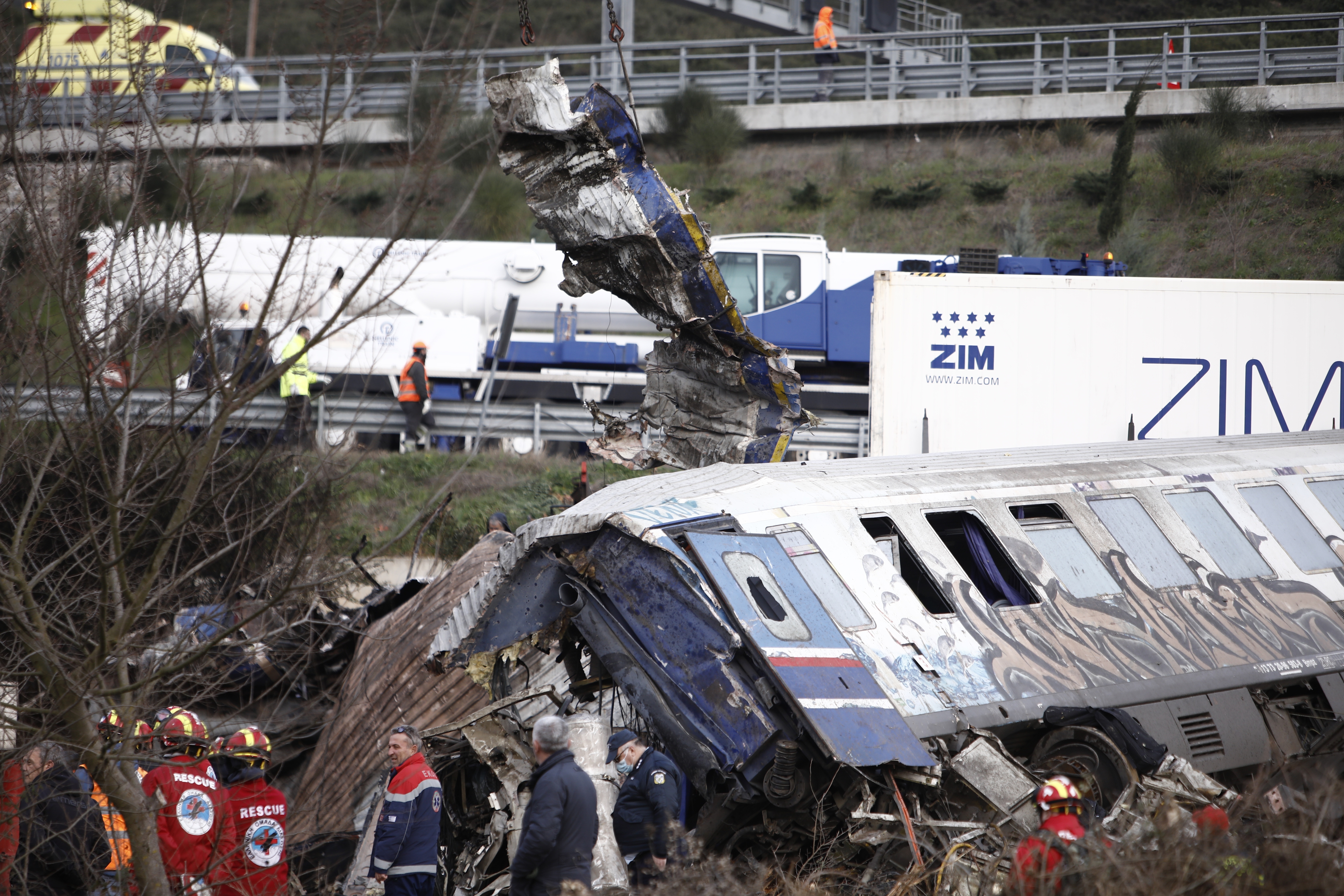 Rescuers stand near debris of trains after a collision in Tempe, about 376 kilometres (235 miles) north of Athens