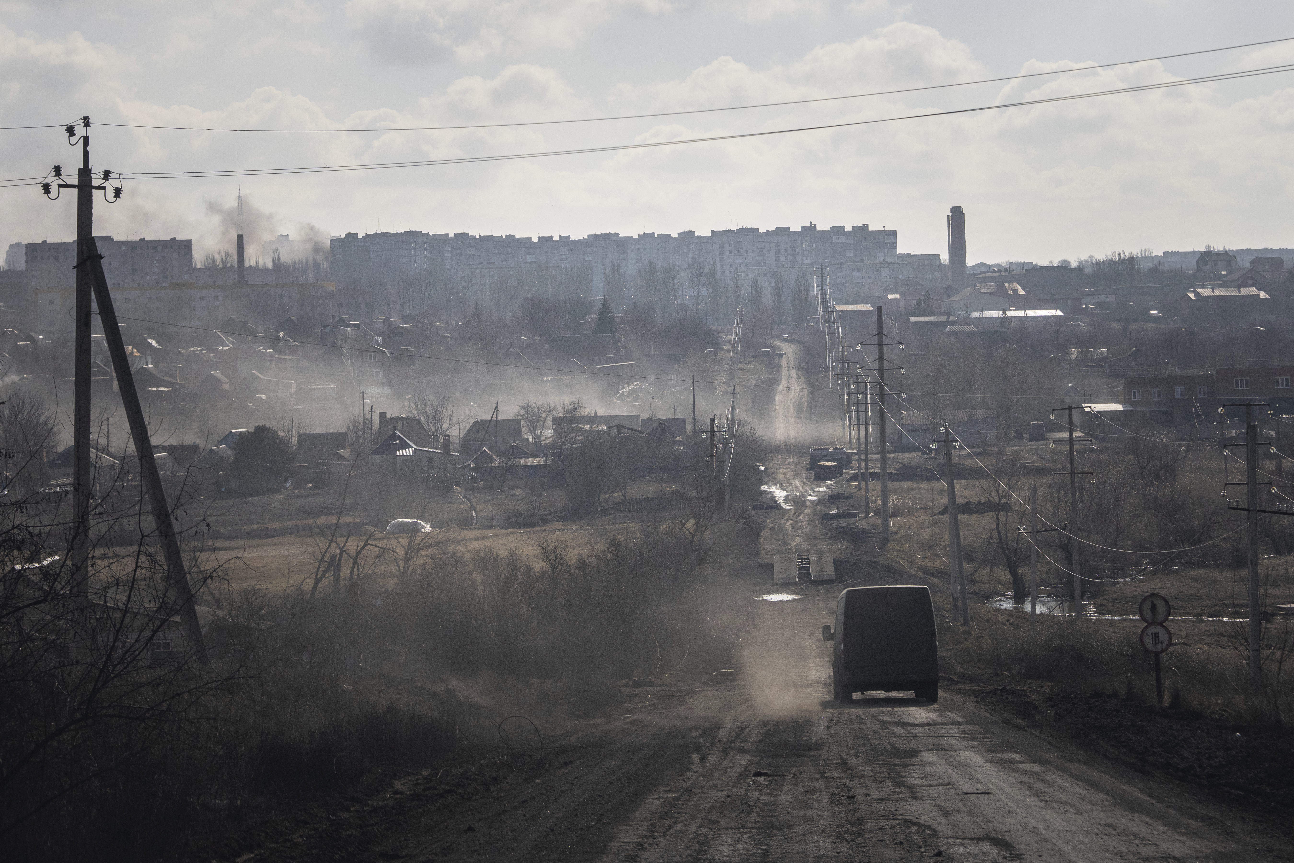 A Ukrainian police van drives on the highway for evacuation civilians in Khromove near Bakhmut