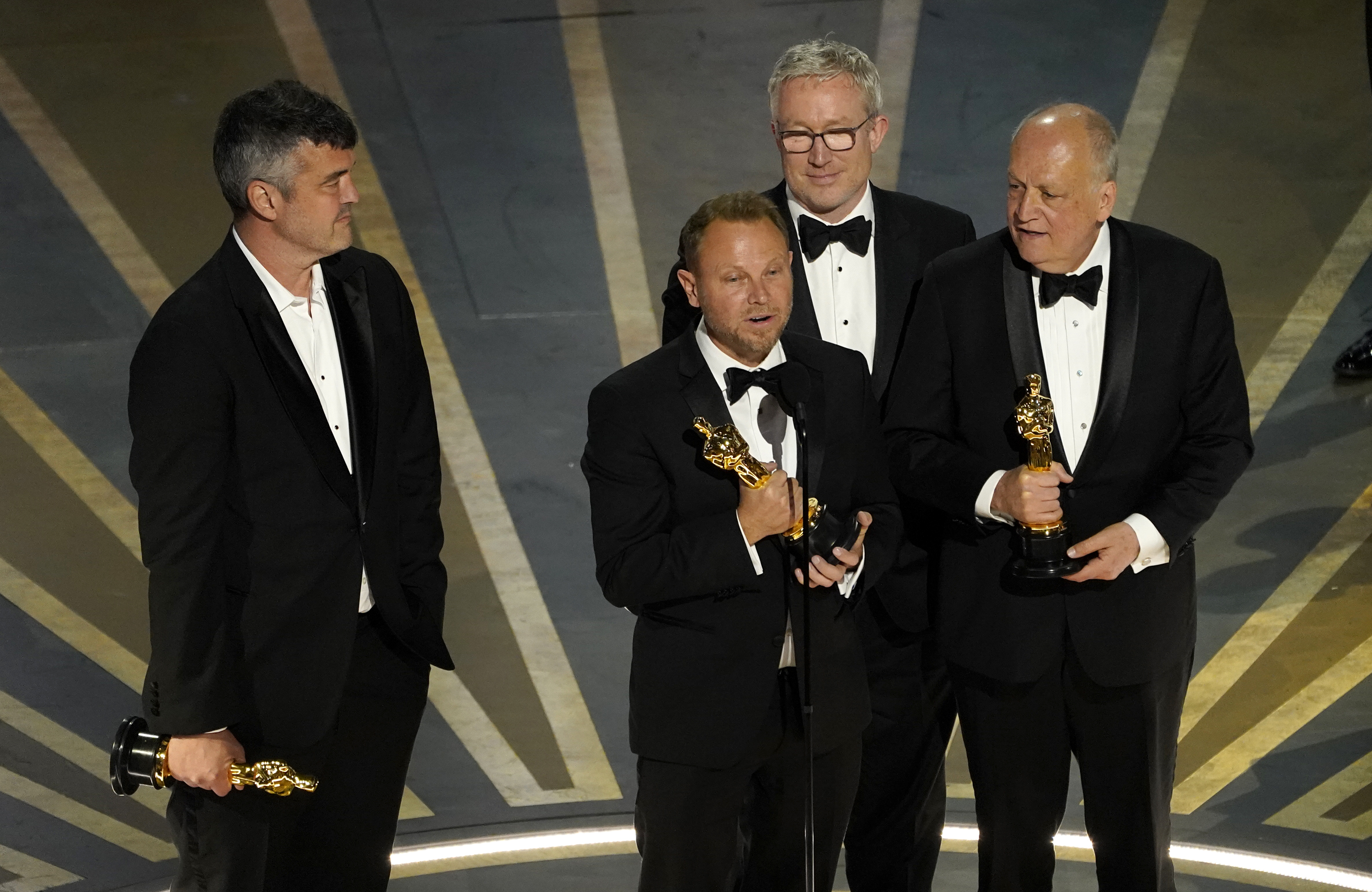 Eric Saindon, from left, Richard Baneham, Daniel Barrett and Joe Letteri accept the award for best visual effects