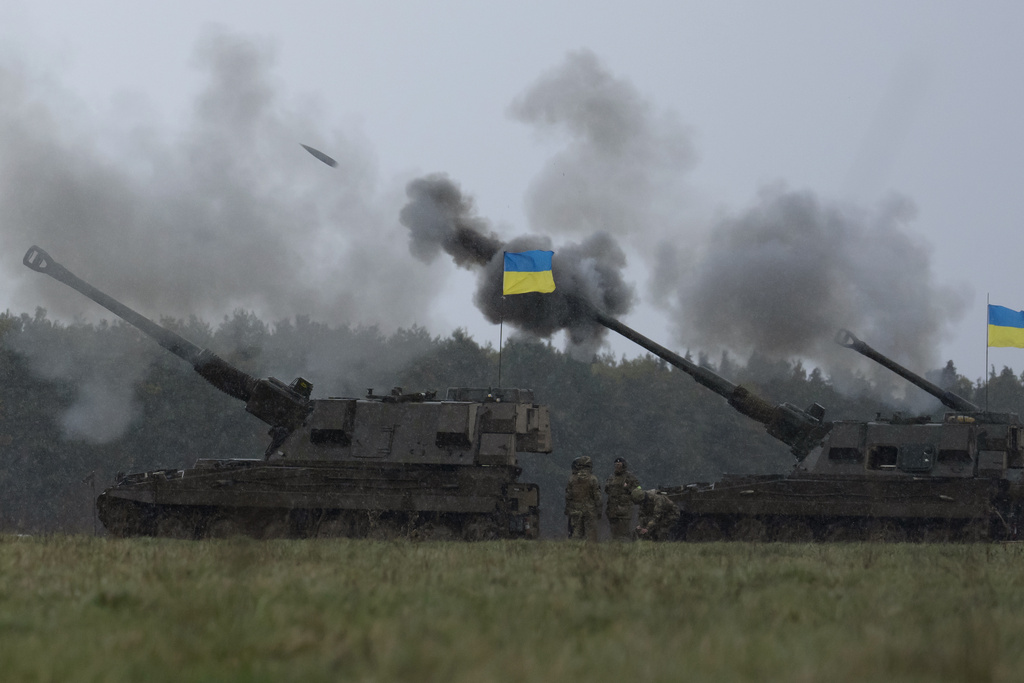 Ukrainian soldiers fire an AS90 as they take part in a military exercise at a military training camp in an undisclosed location in England, Friday, March 24, 2023. The second cohort of Ukrainian artillery recruits come to the end of their training on the formidable AS90 155mm self-propelled gun. (AP Photo/Kin Cheung)