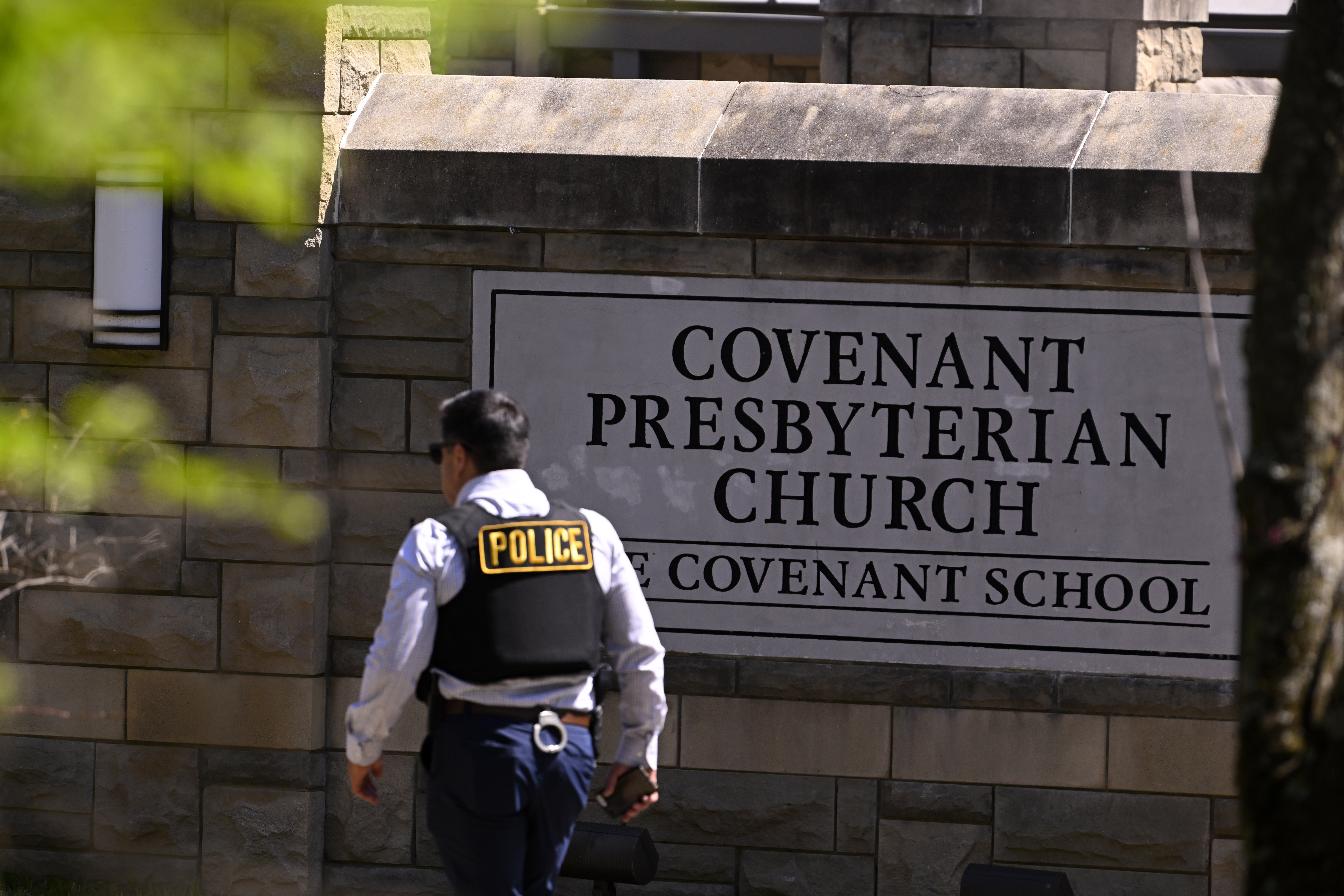 A police officer walks by an entrance to The Covenant School after the shooting in Nashville, Tennessee.