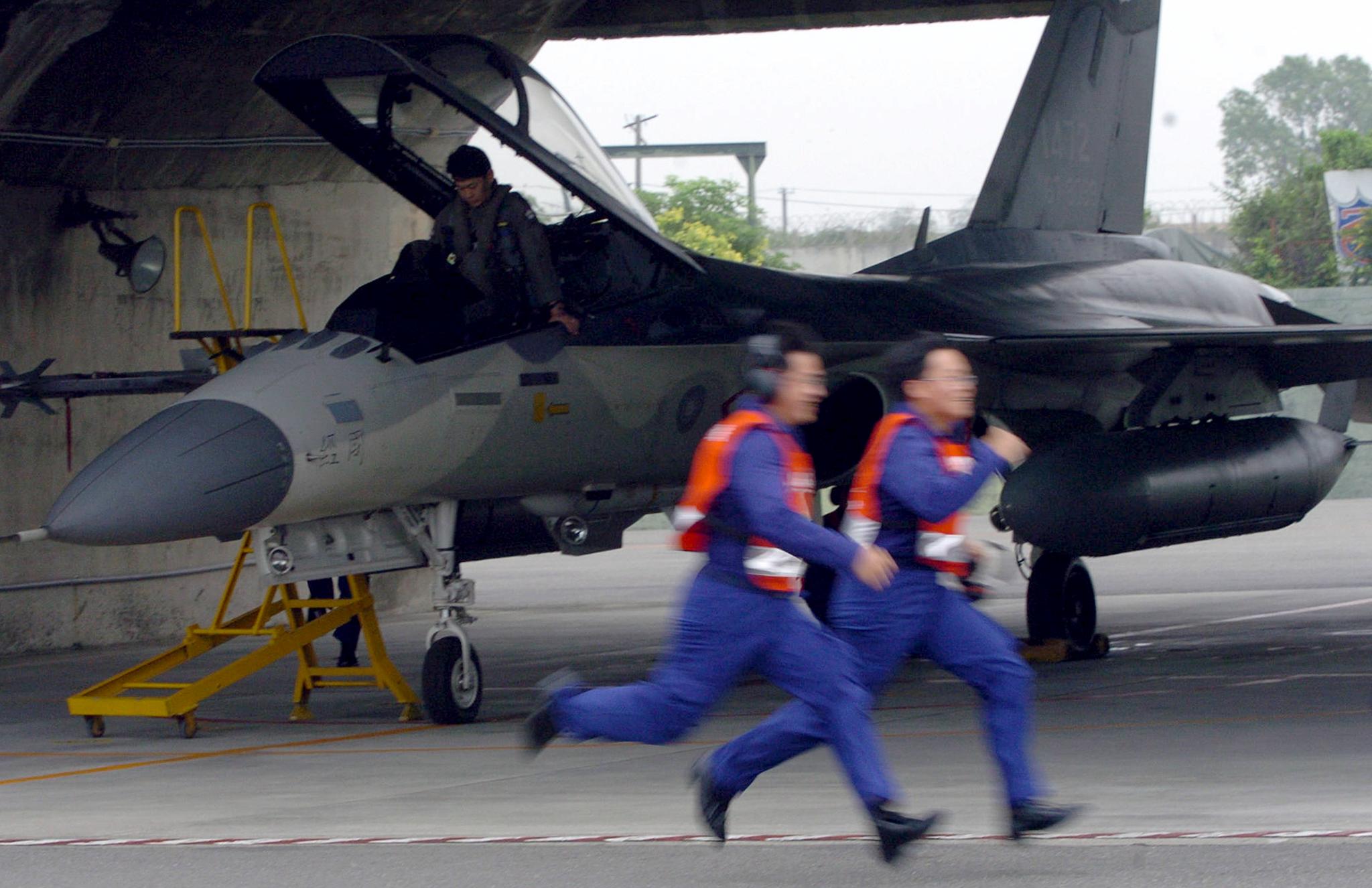 Two pilot run past a Defensive Fighter