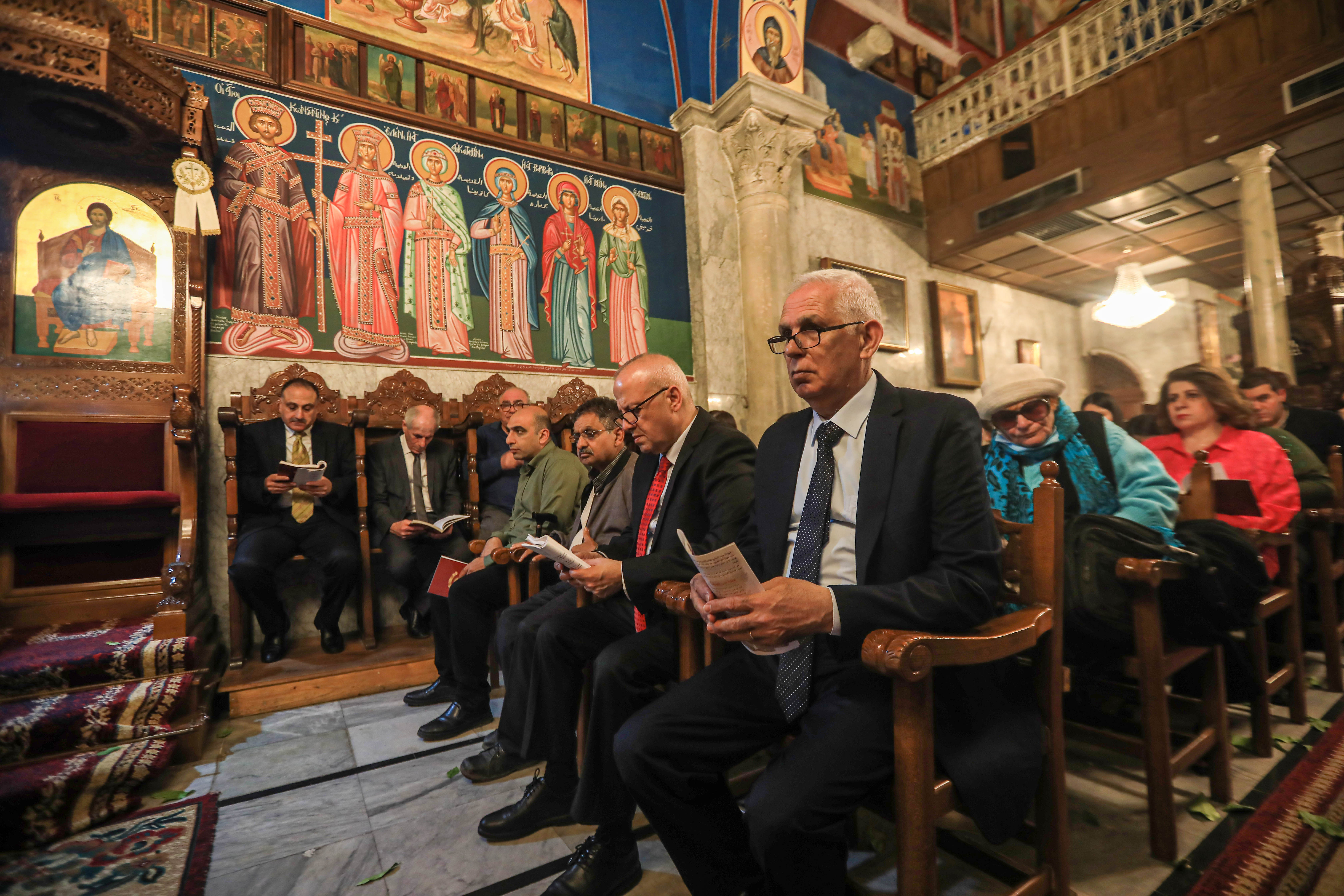 Worshippers reading from their hymnals in church