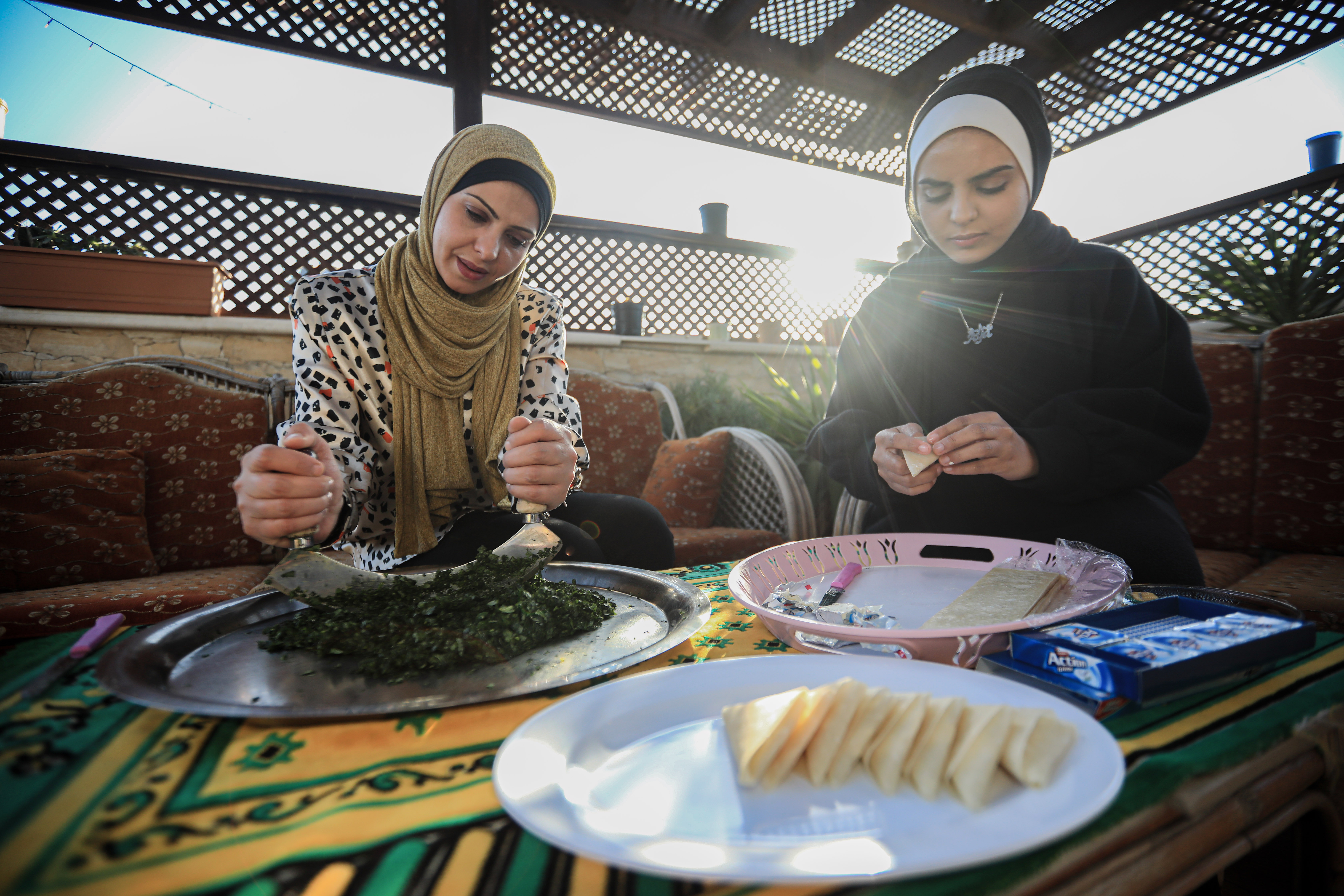 Siham Abu Shaaban and her mother prepare molokia and other iftar dishes