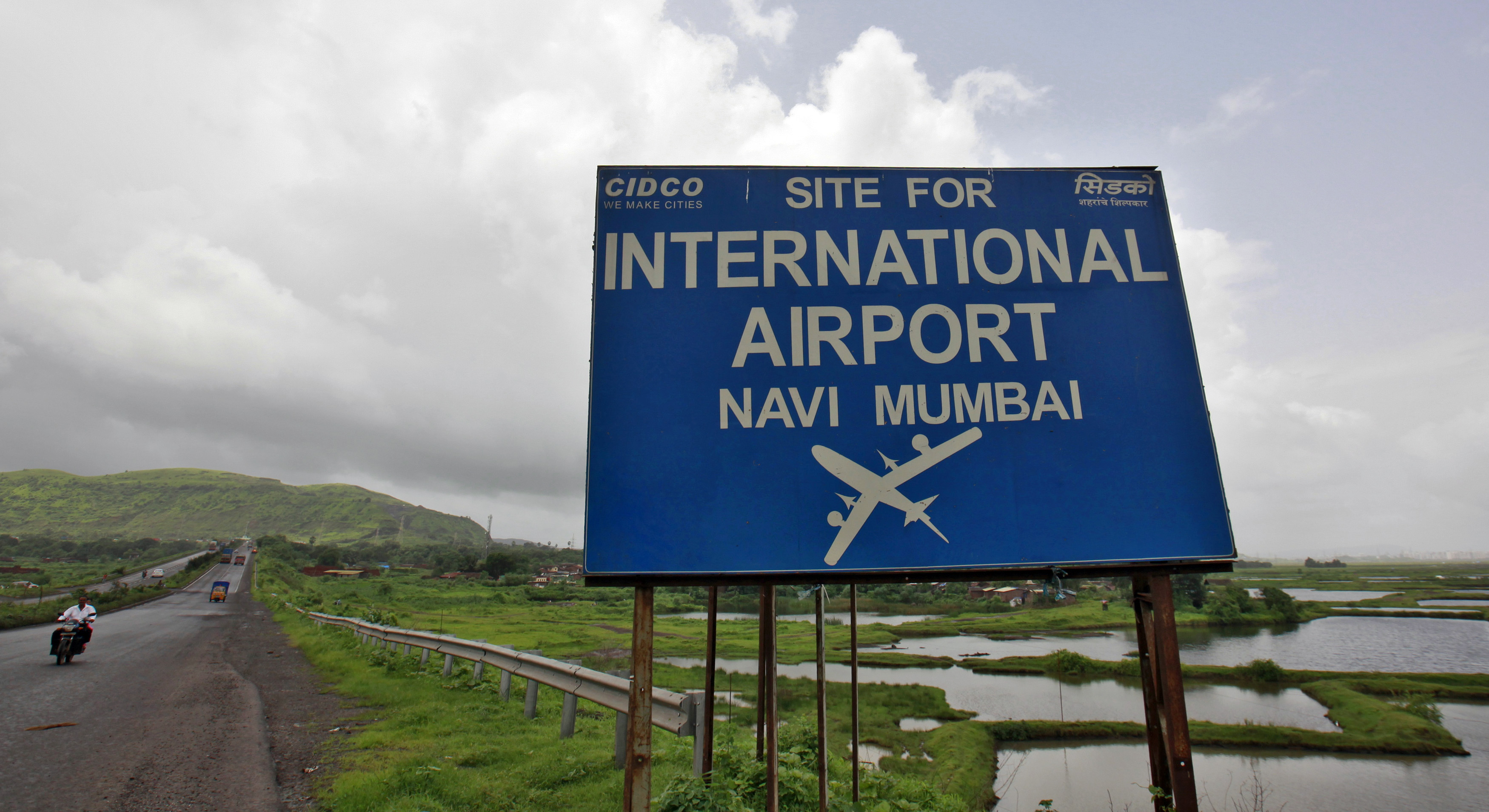A signboard at the proposed site of the Navi Mumbai airport, about 45km (27 miles) east of Mumbai, India.