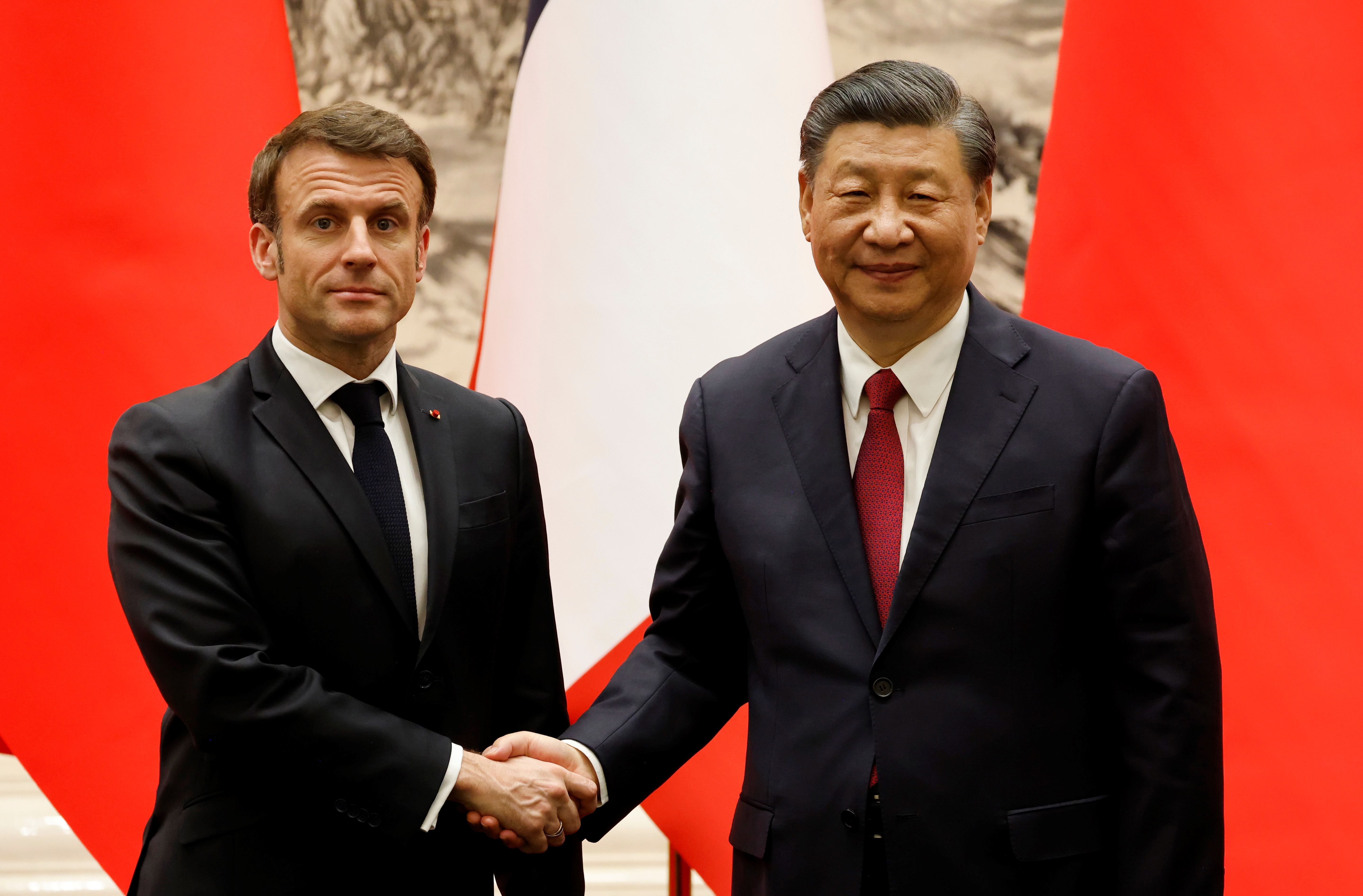 Chinas President Xi Jinping shakes hands with French President Emmanuel Macron