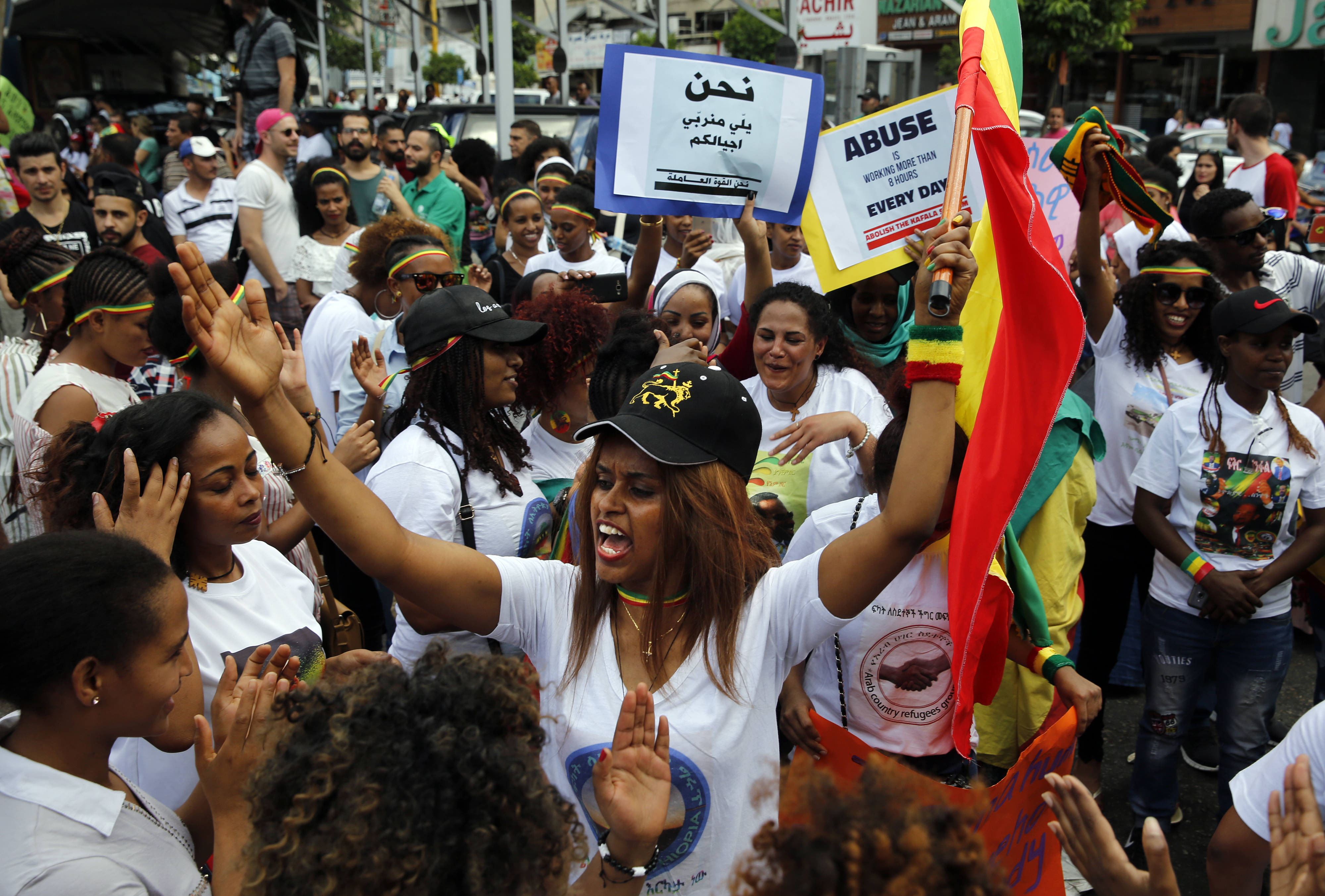 An Ethiopian migrant domestic worker chants slogans as she holds her national flag during a rally to mark International Domestic Workers Day, in Beirut, Lebanon, Sunday, June 24, 2018 [Bilal Hussein/AP Photo]