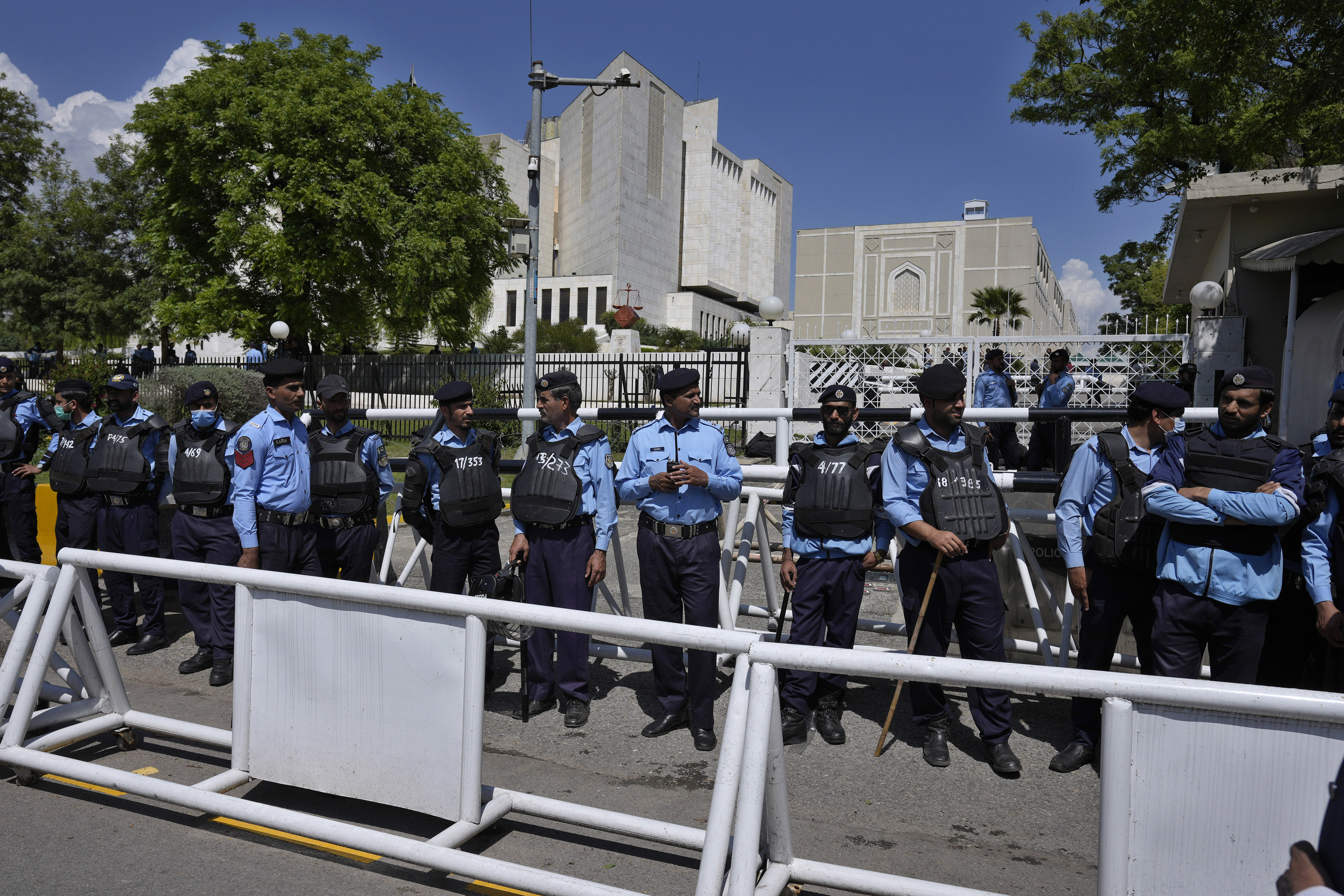 Police officers stand guard outside the Supreme Court to ensure security, in Islamabad, Pakistan, Tuesday, April 4, 2023.