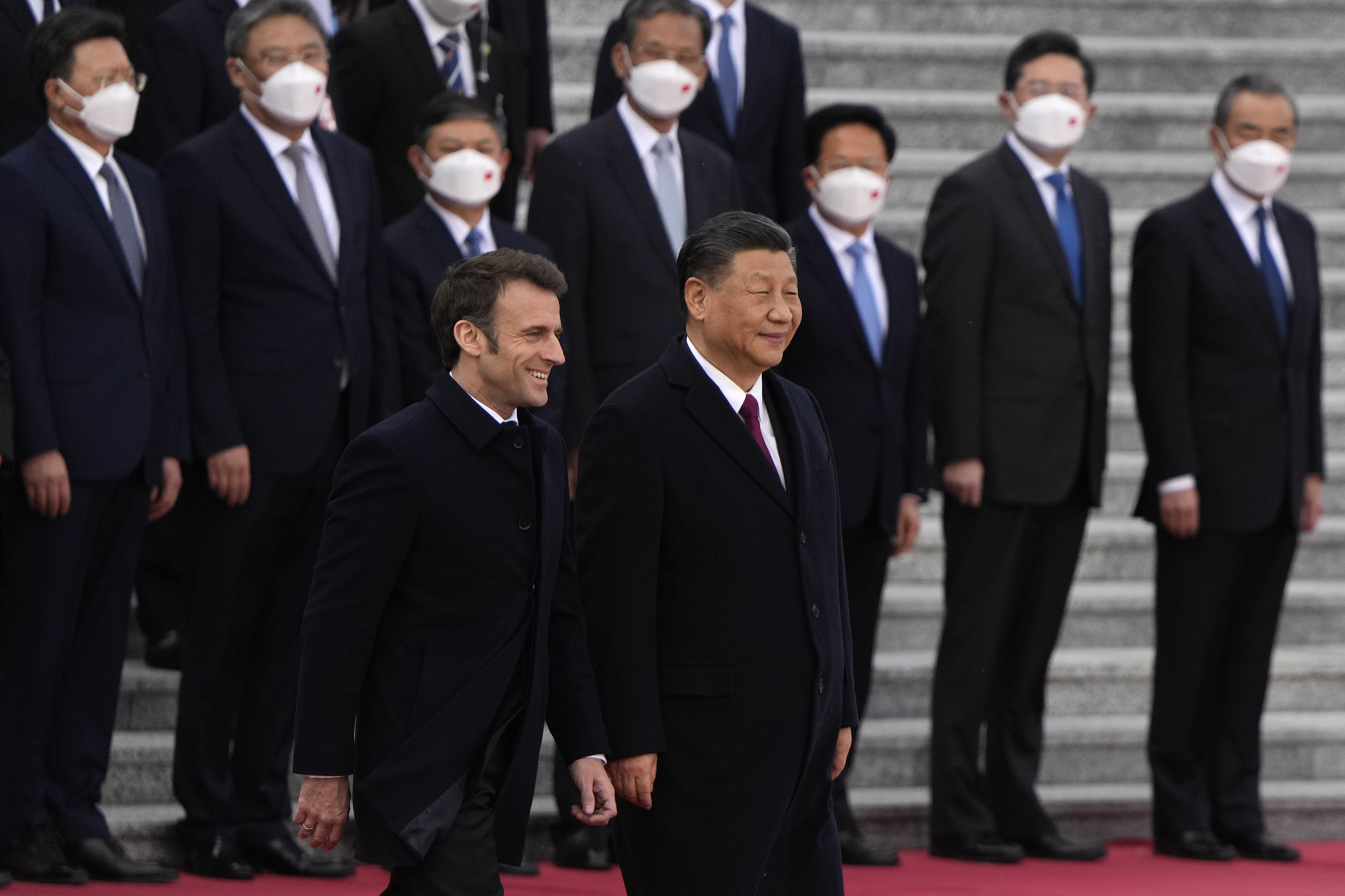 French President Emmanuel Macron, bottom left, walks with Chinese President Xi Jinping during a welcome ceremony held outside the Great Hall of the People in Beijing