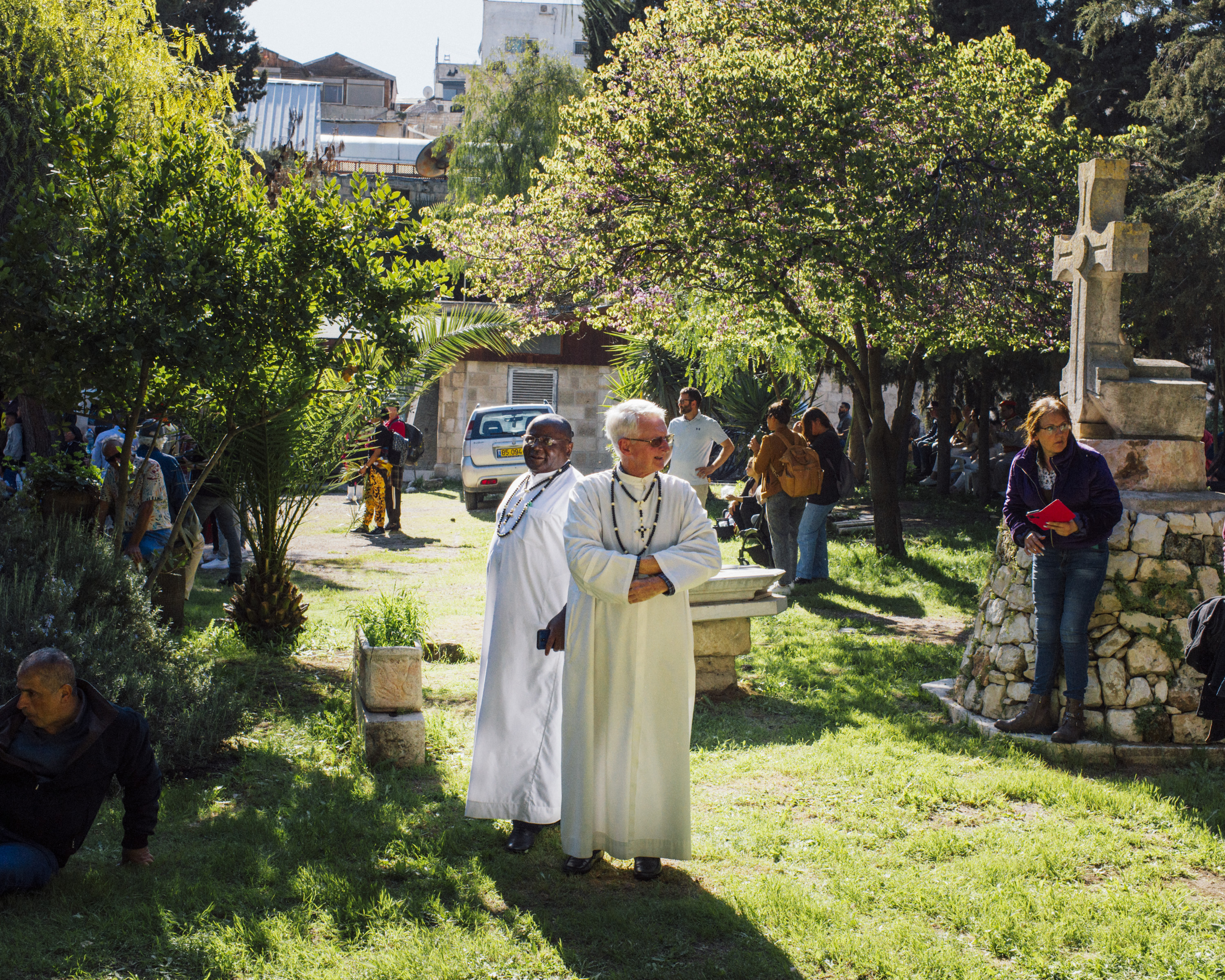 Priests in white on the grass