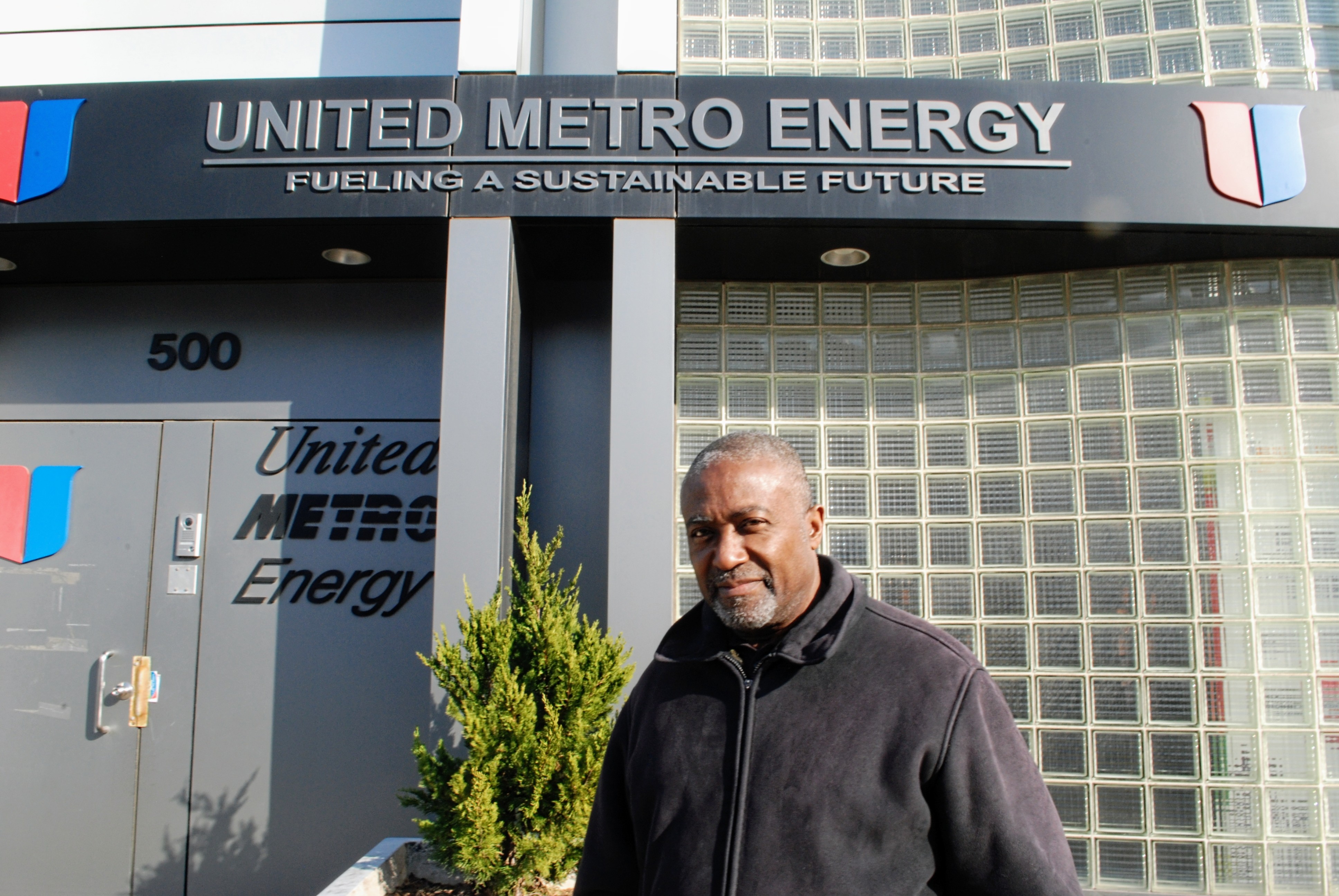 A photo of Andre Soleyn outside the United Metro Energy Corporation (UMEC) building.