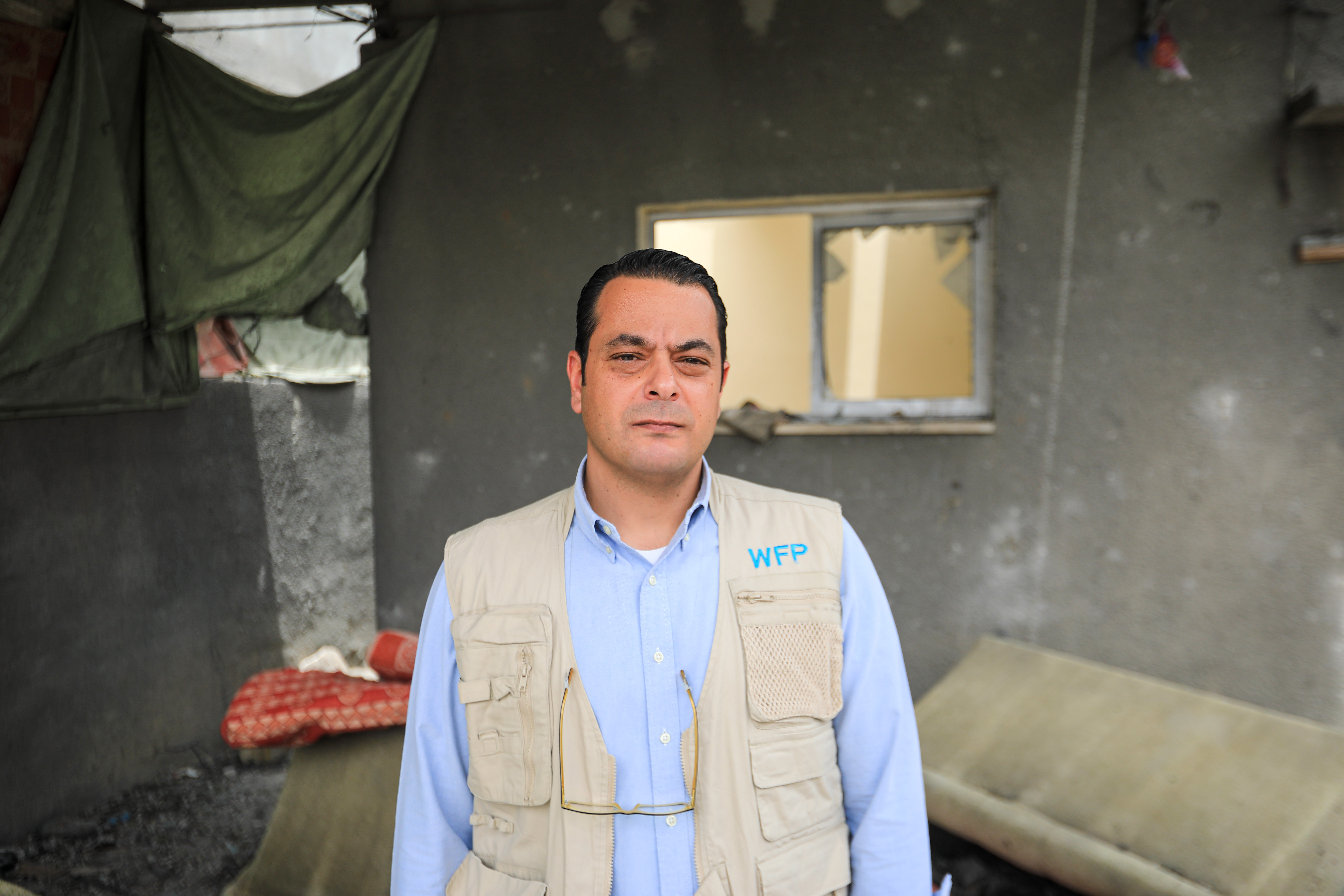 A man visits a destroyed home