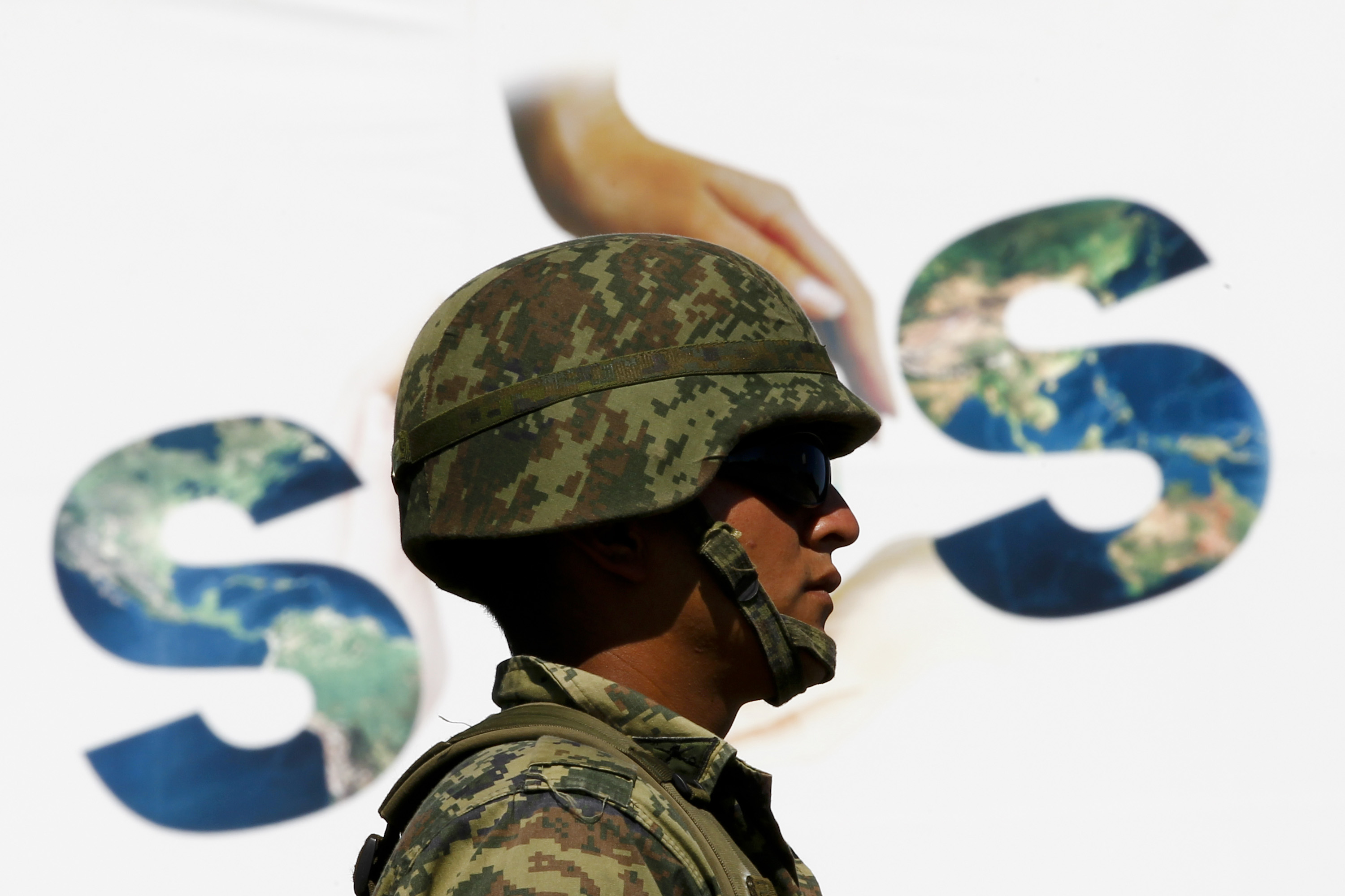 A soldier guards the venue of U.N. climate talks in Cancun December 10, 2010.