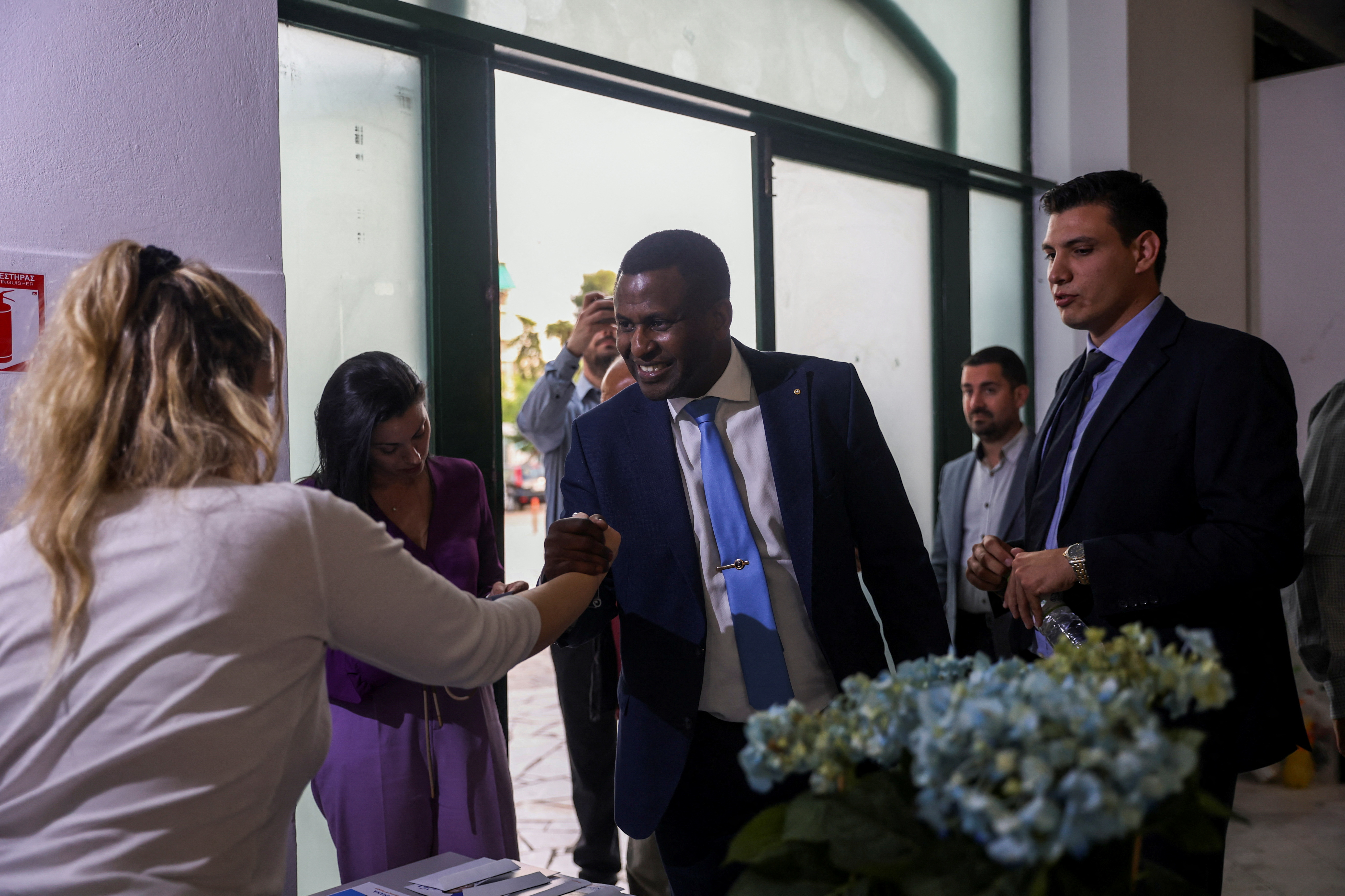 Conservative New Democracy party candidate Spiros Richard Hagabimana arrives for an election campaign event at the neighbourhood of Nikaia, near Athens