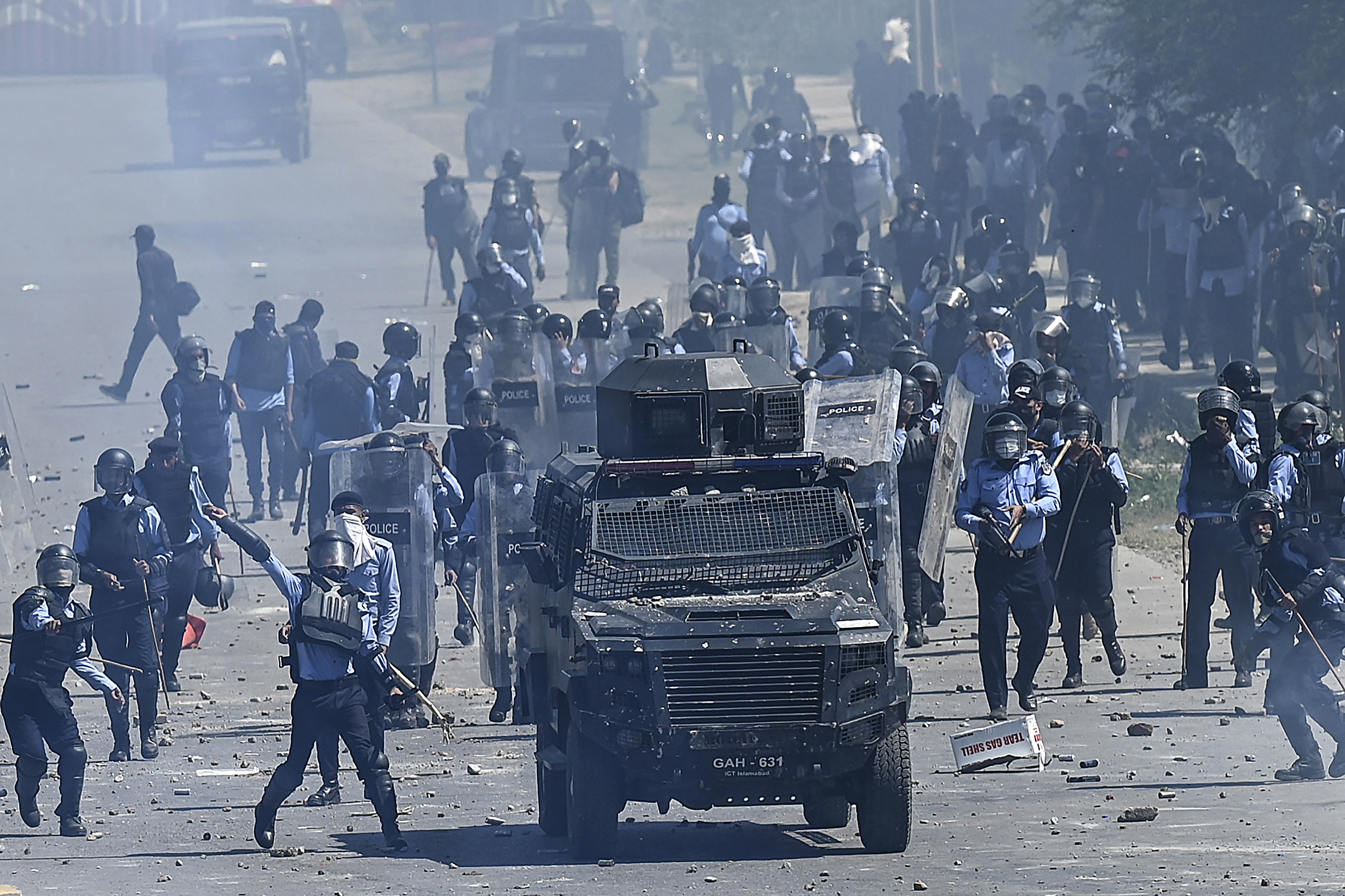 Pakistan Tehreek-e-Insaf (PTI) party activists and supporters (unseen) of former Pakistan's Prime Minister Imran Khan clash with police during a protest against the arrest of their leader, in Islamabad