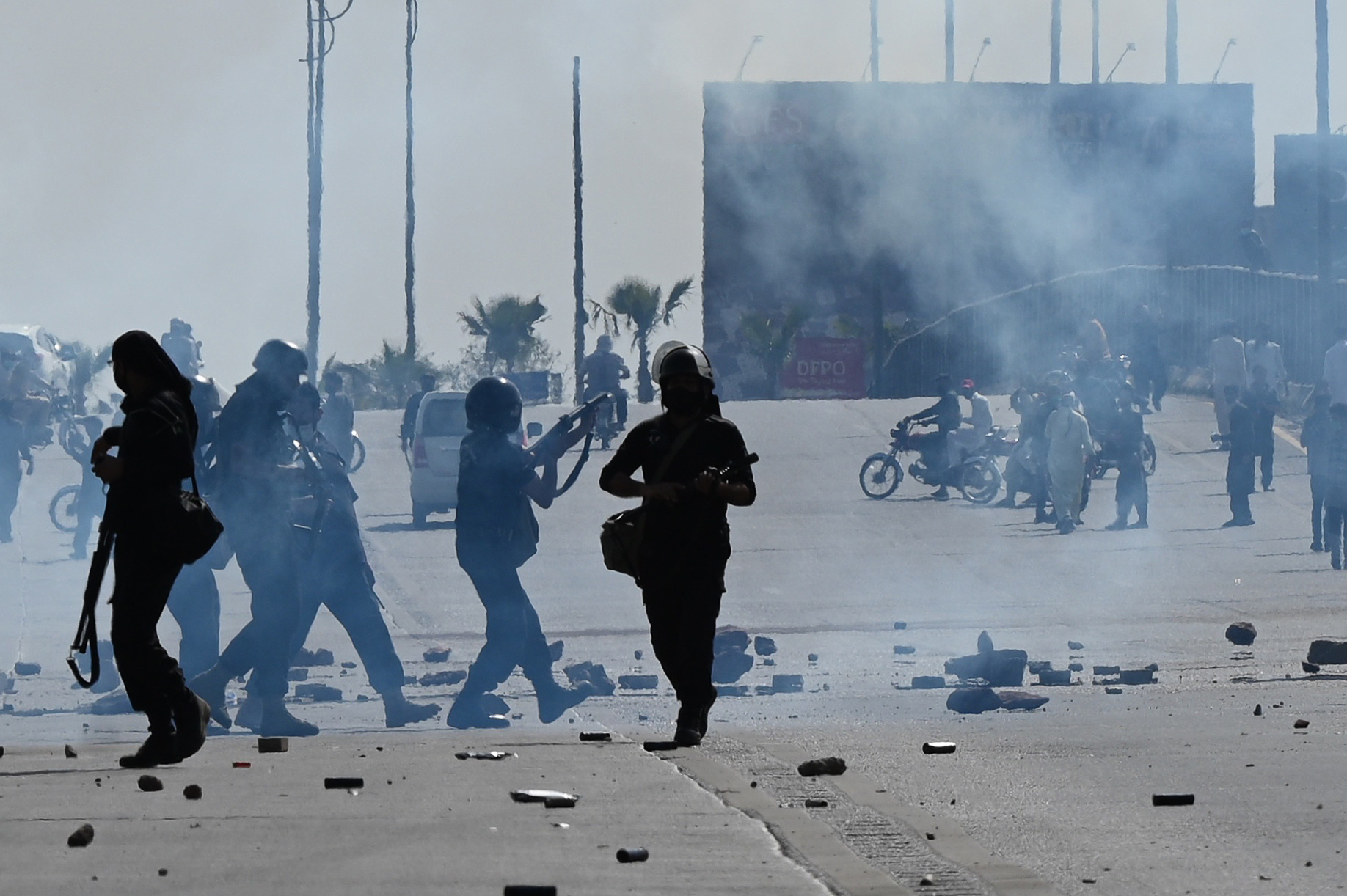 Policemen fire teargas shells to disperse Pakistan Tehreek-e-Insaf (PTI) party activists and supporters of former Pakistan's Prime Minister Imran Khan trying to reach the Islamabad High Court during Khan's hearing, in Islamabad