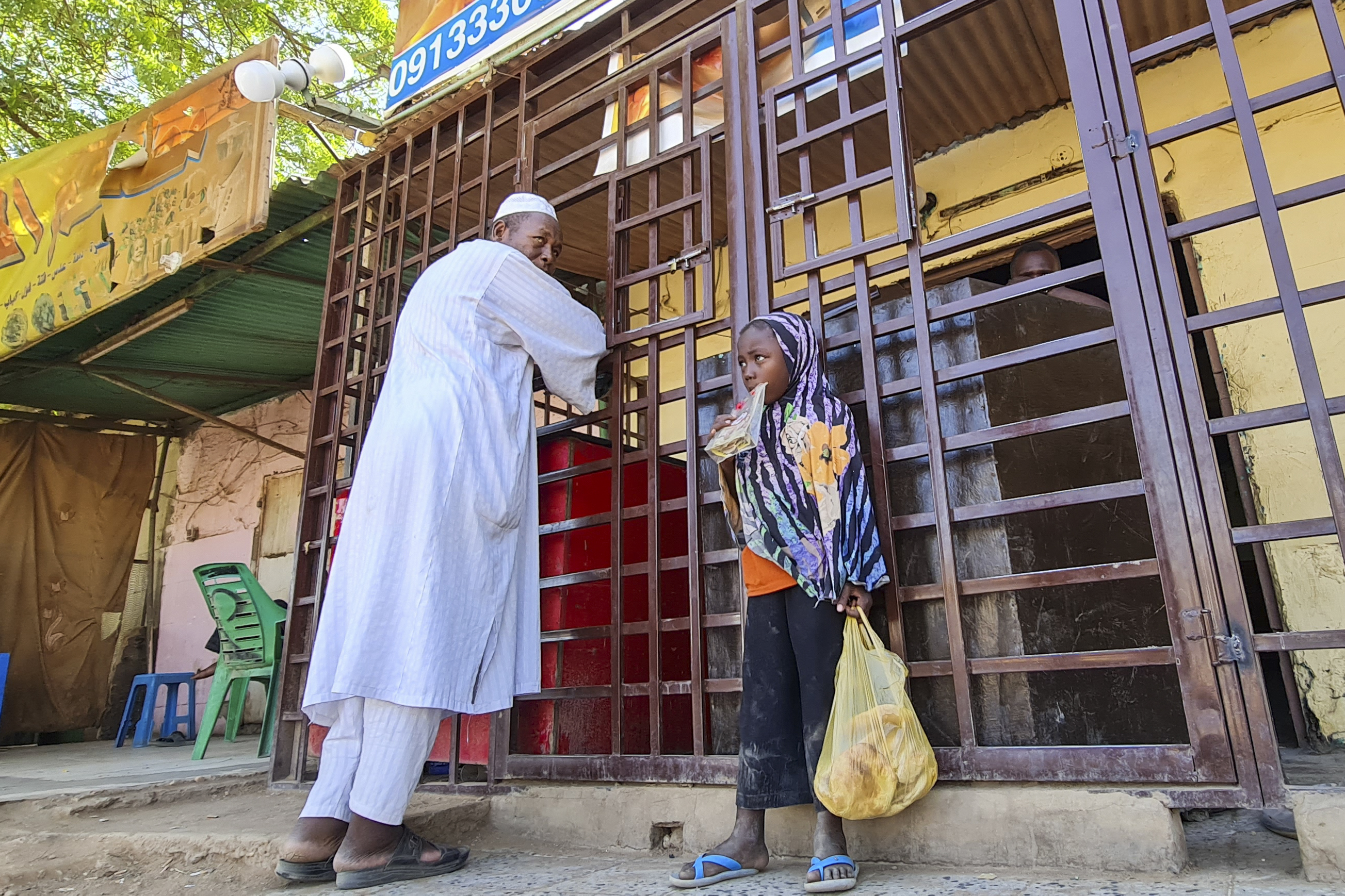 People buy provisions in southern Khartoum