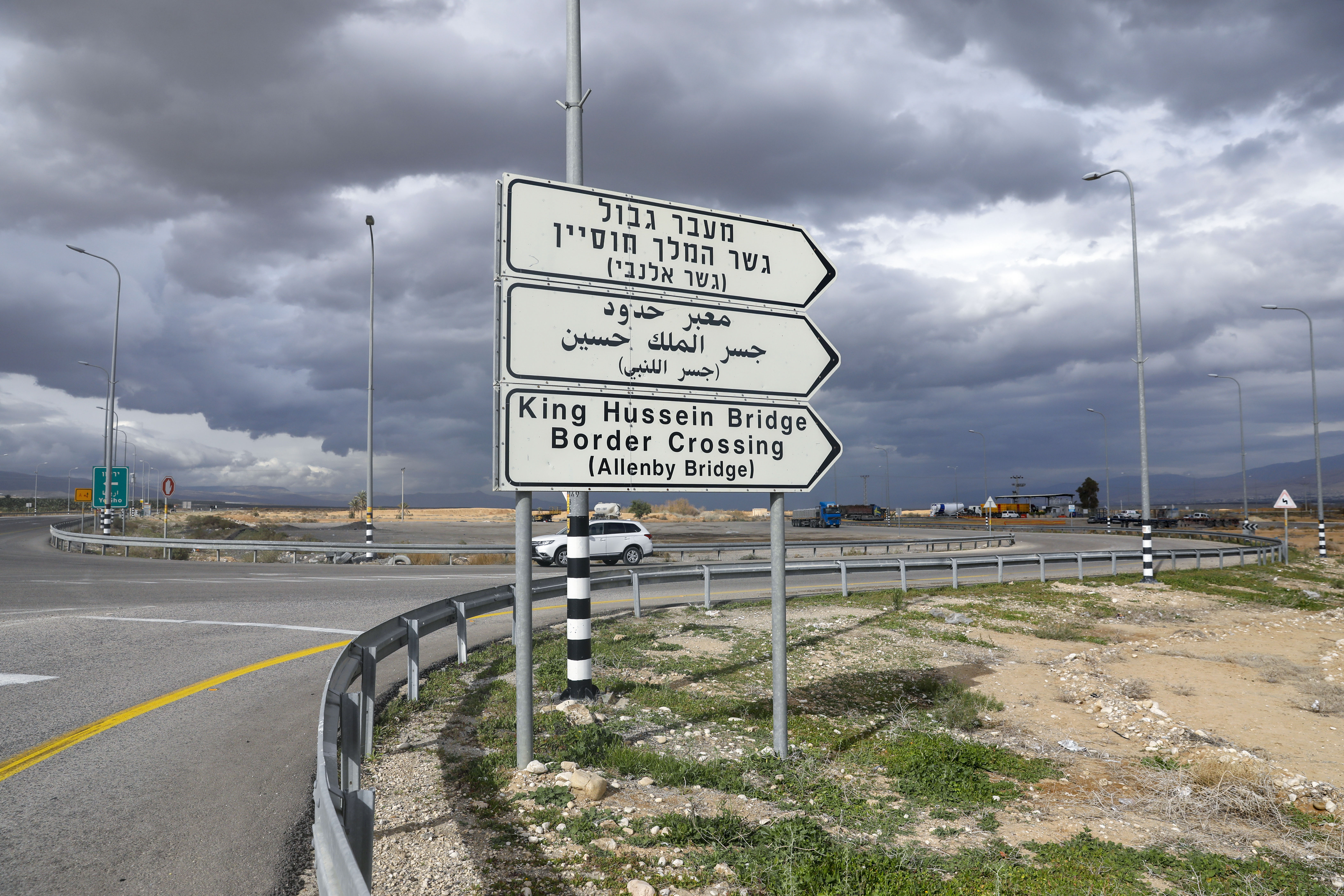 A car drives past a road signal indicating the King Hussein (Allenby) Bridge crossing point to Jordan in Jericho in the occupied West Bank