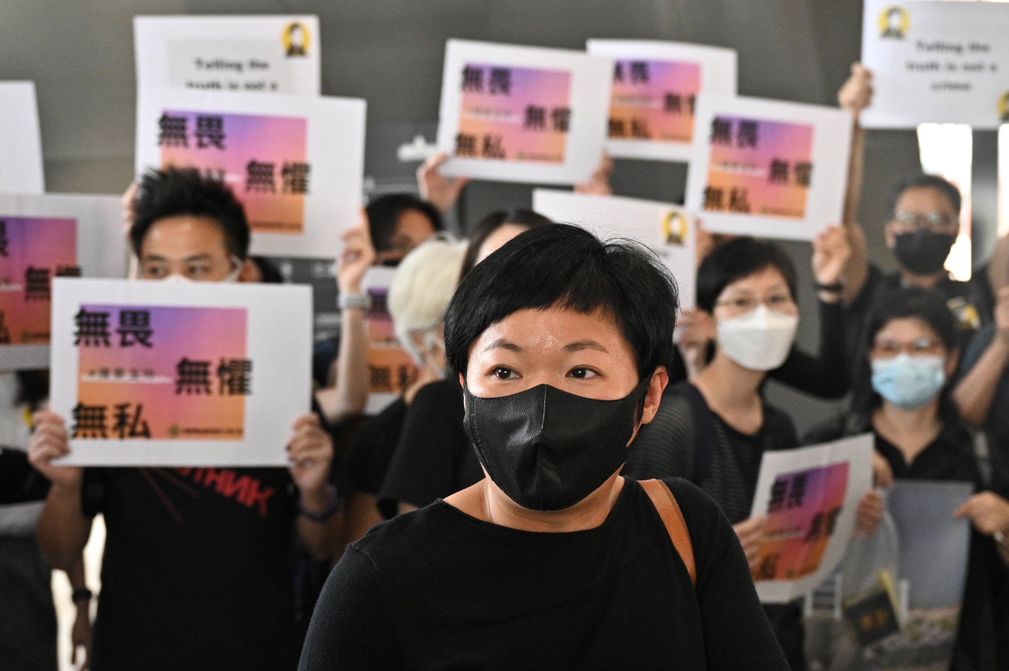 Bao Choy, with supporters behind her, pictured after eacts as she speaks to the press at the West Kowloon Courts building in Hong Kong on April 22, 2021, after she was found guilty of improperly searching a public vehicle licence database to help track down the perpetrators of an attack on