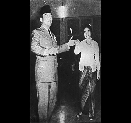 Sukarno, as Indonesia President, dances with daughter Megawati Sukarnoputri , Jakarta, Indonesia, black and white photo [AP]