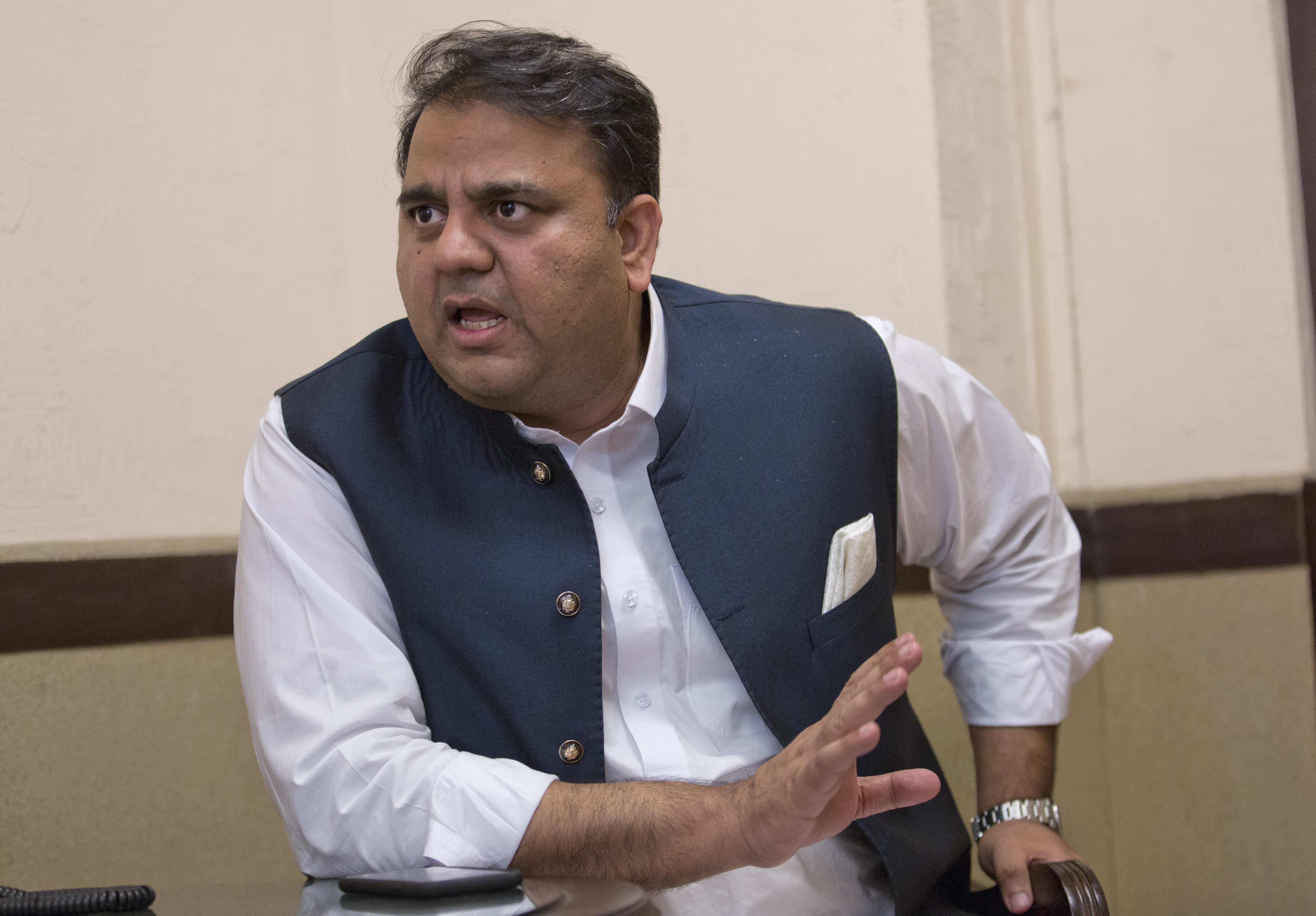 In this Tuesday, Sept. 25, 2018 photo, Pakistani Information Minister Fawad Chaudhry speaks to The Associated Press, in Islamabad, Pakistan. The Ahmadiyya minority fears heightened persecution after the new government bowed to demands from Islamic hard-liners to rescind the appointment of a U.S.-based Ahmadi professor to an economic advisory council. Chaudhry sought to stem the controversy by pointing out that the position had nothing to do with religion or lawmaking, and that the newly elected government wanted to be inclusive. (AP Photo/B.K. Bangash)