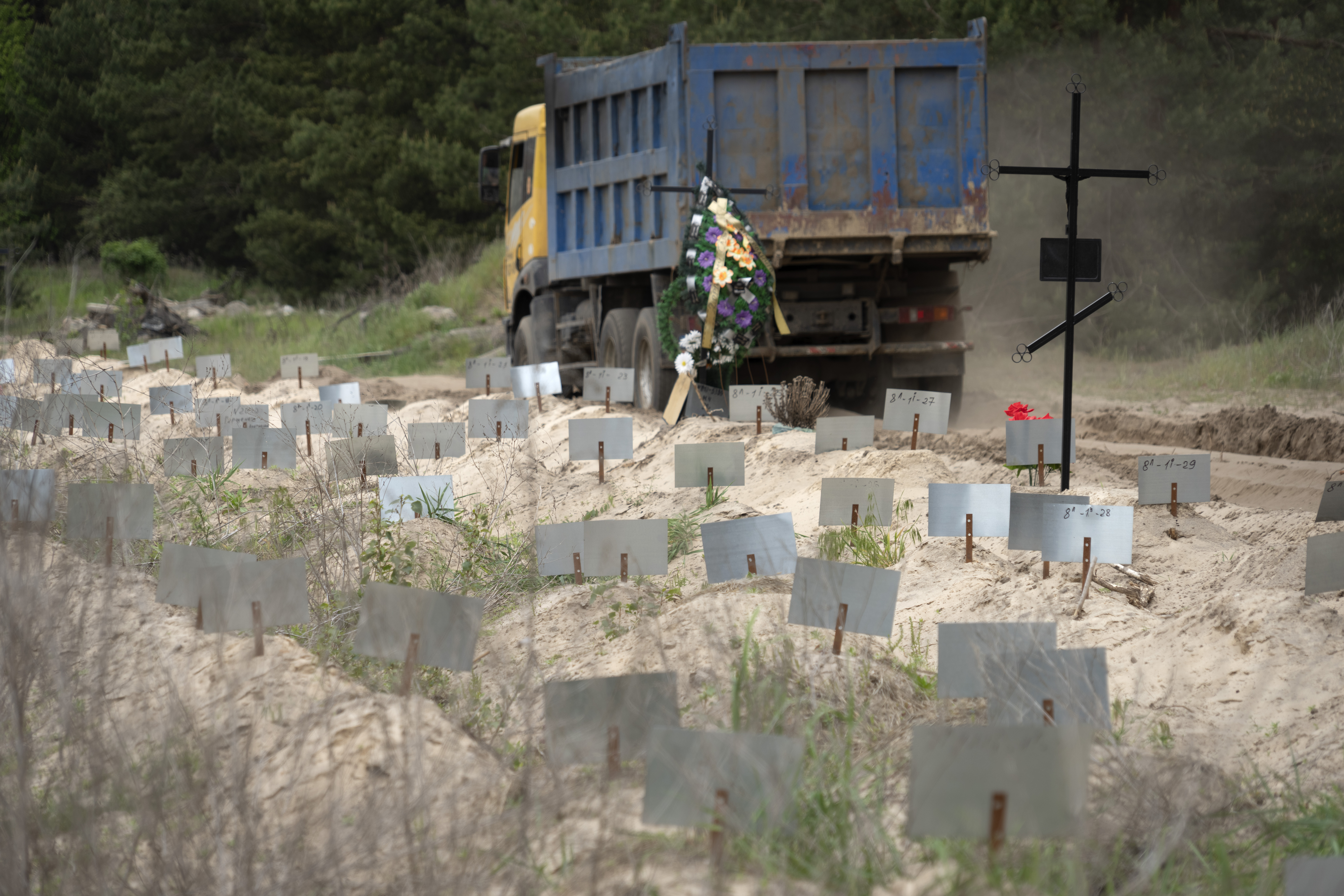 Hundreds of graves, mostly unnamed, where the remains of civilians killed by Russian forces are buried, close to a town cemetery near Brovary, east of the capital Kyiv, Ukraine, Wednesday, May 17, 2023. (AP Photo/Efrem Lukatsky)