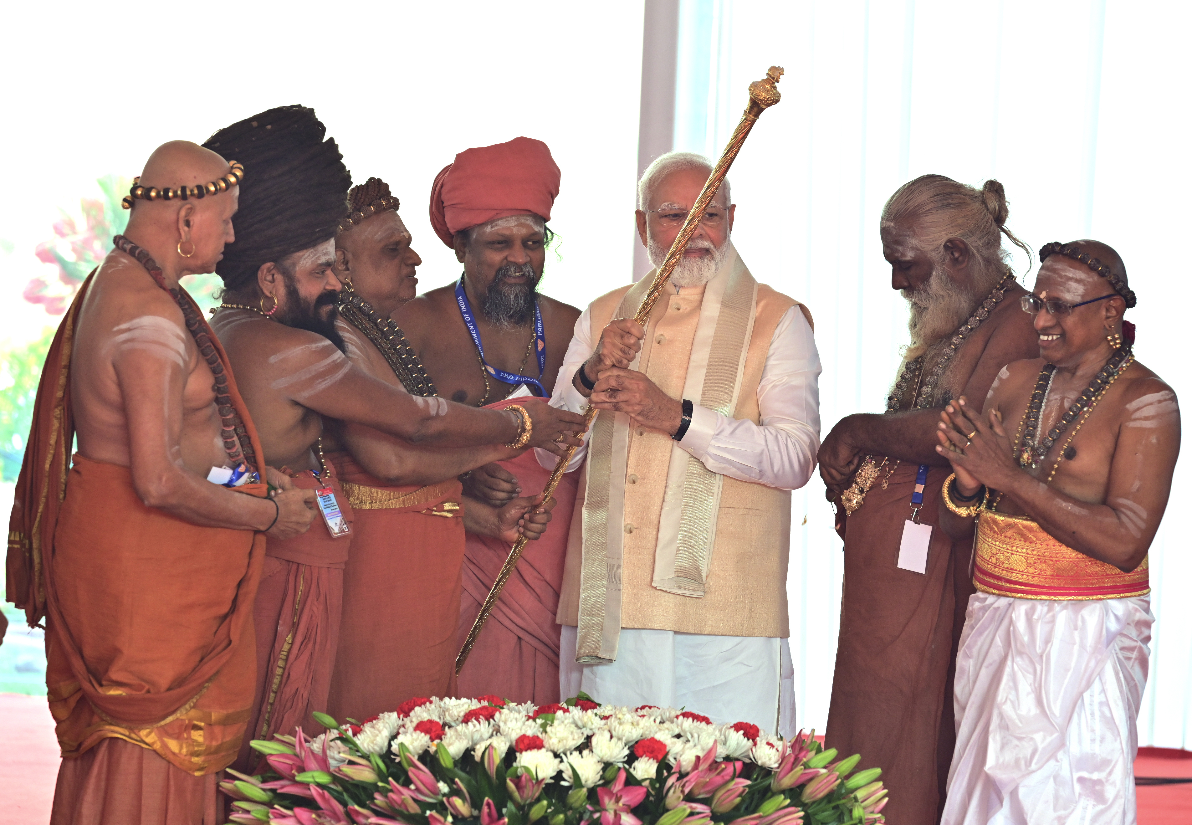 Hindu priests hand over a royal golden sceptre to Indian prime minister Narendra Modi to be installed near the chair of the speaker during the start of the inaugural ceremony of the new parliament building, in New Delhi, India, Sunday, 28 May 2023. The new triangular parliament building, built at an estimated cost of $120 million, is part of a $2.8 billion revamp of British-era offices and residences in central New Delhi called "Central Vista", even as India's major opposition parties boycotted the inauguration, in a rare show of unity against the Hindu nationalist ruling party that has completed nine years in power and is seeking a third term in crucial general elections next year