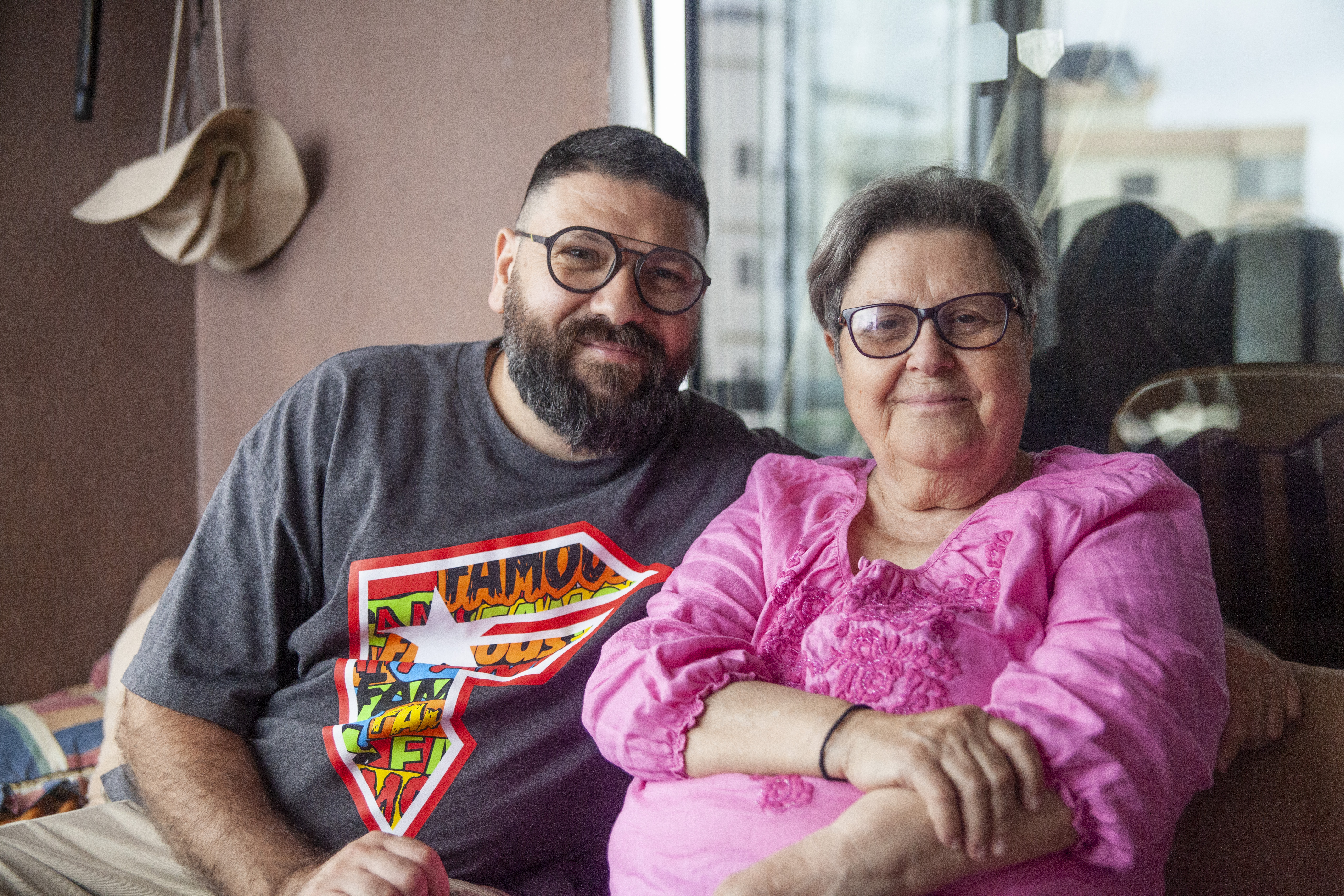 A photo of Chadi sitting next to his mother Hala on her balcony.