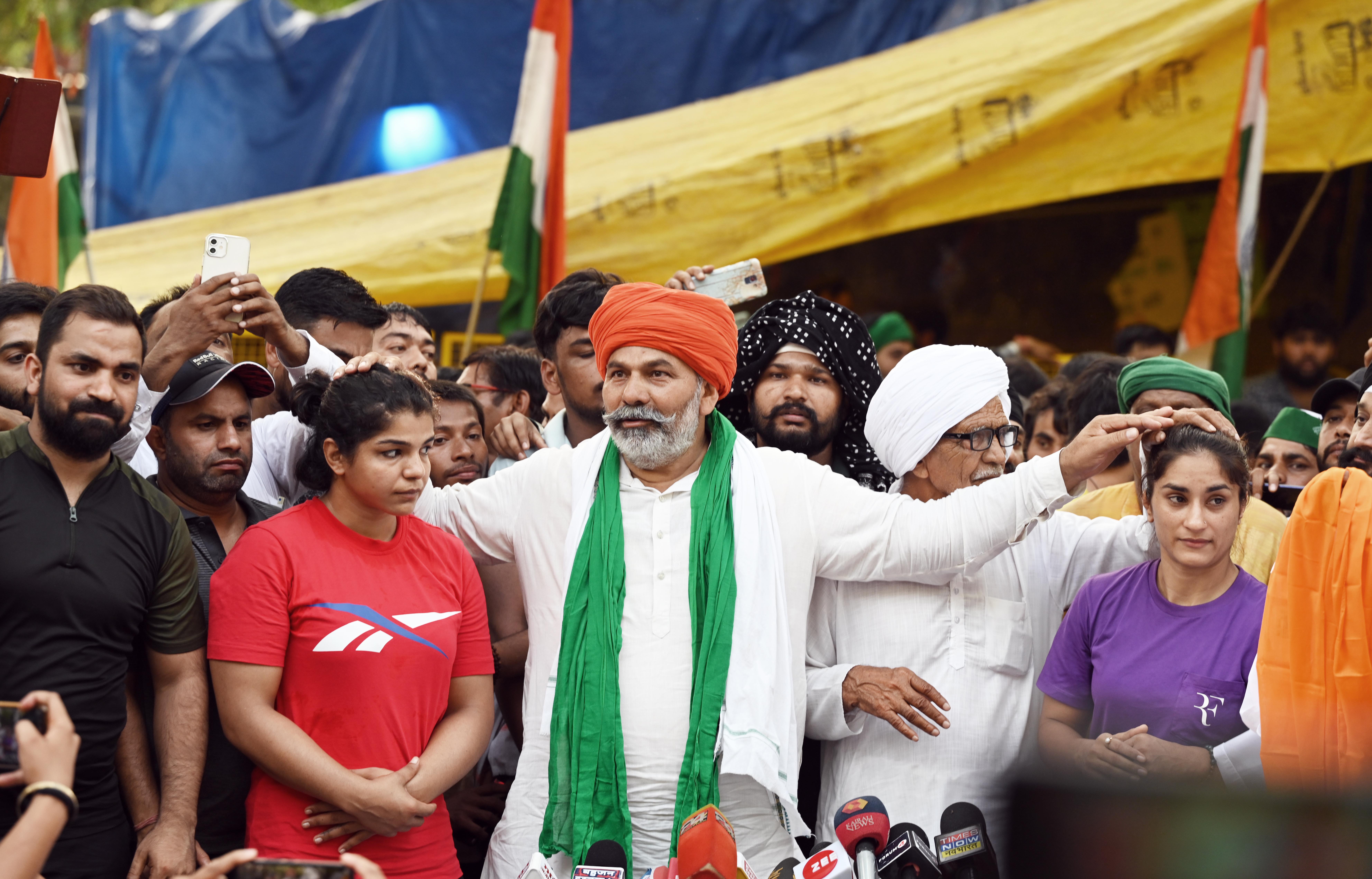 Farmer leaders Rakesh Tikait and Mehar Singh along with wrestlers Sakshi Malik and Vinesh Phogat speak with the media during wrestlers' protest at Jantar Mantar, on May 7, 2023 in New Delhi, India. Wrestlers resumed their protest against WFI and its President Brij Bhushan Sharan Singh. The protesting wrestlers accused the WFI president of sexually harassing several