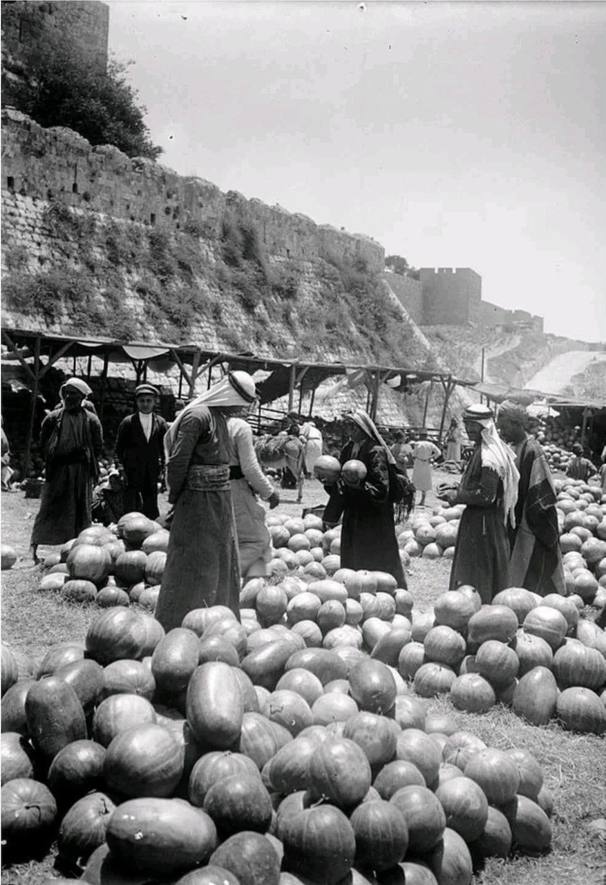 Watermelon market outside Jaffa Gate at the base of the Citadel walls, Jerusalem, 1900 [BMJ]