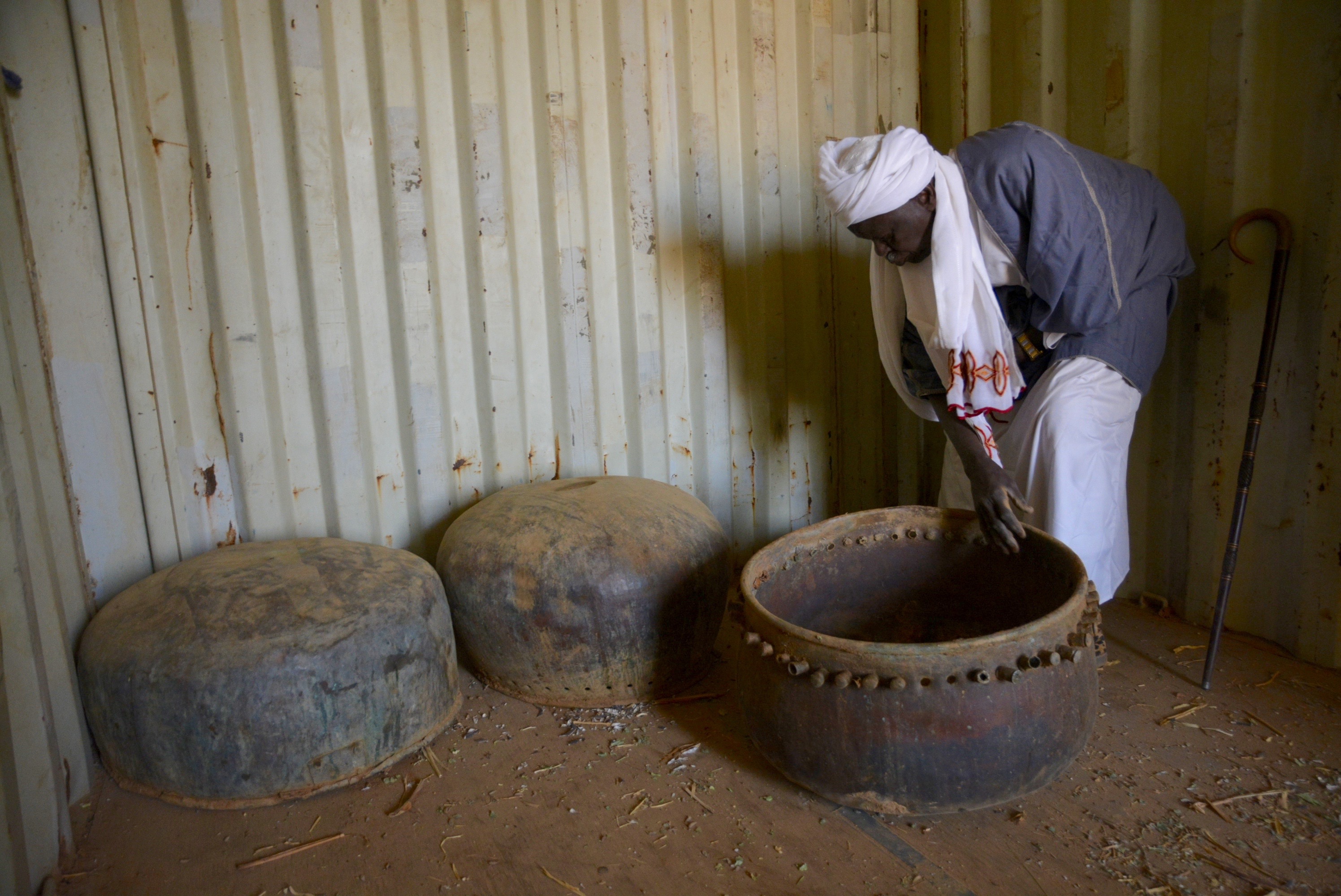 A village chief in Sudan with copper drums that symbolise power