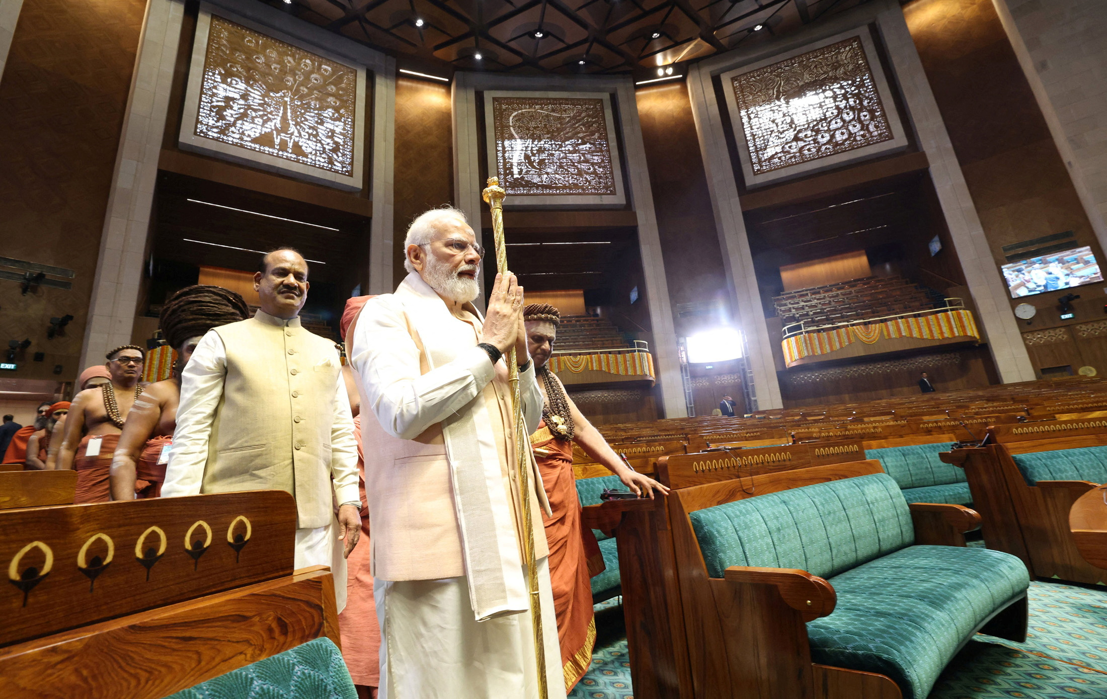 Prime Minister Narendra Modi carries a sengol as Lok Sabha Speaker Om Birla looks on during the inauguration of the new Parliament building in New Delhi, May 28, 2023