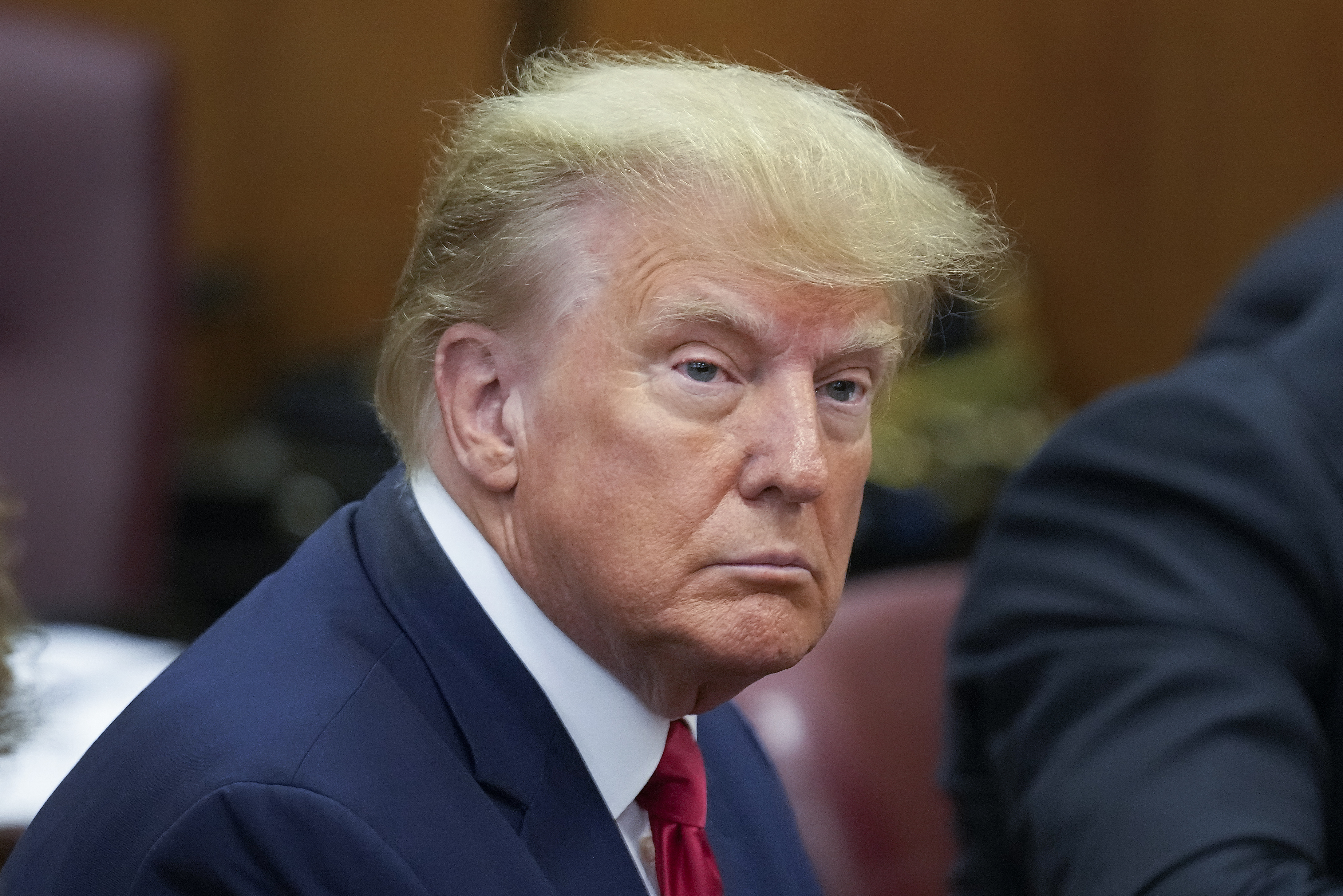 Former President Donald Trump sits at the defense table in a Manhattan court