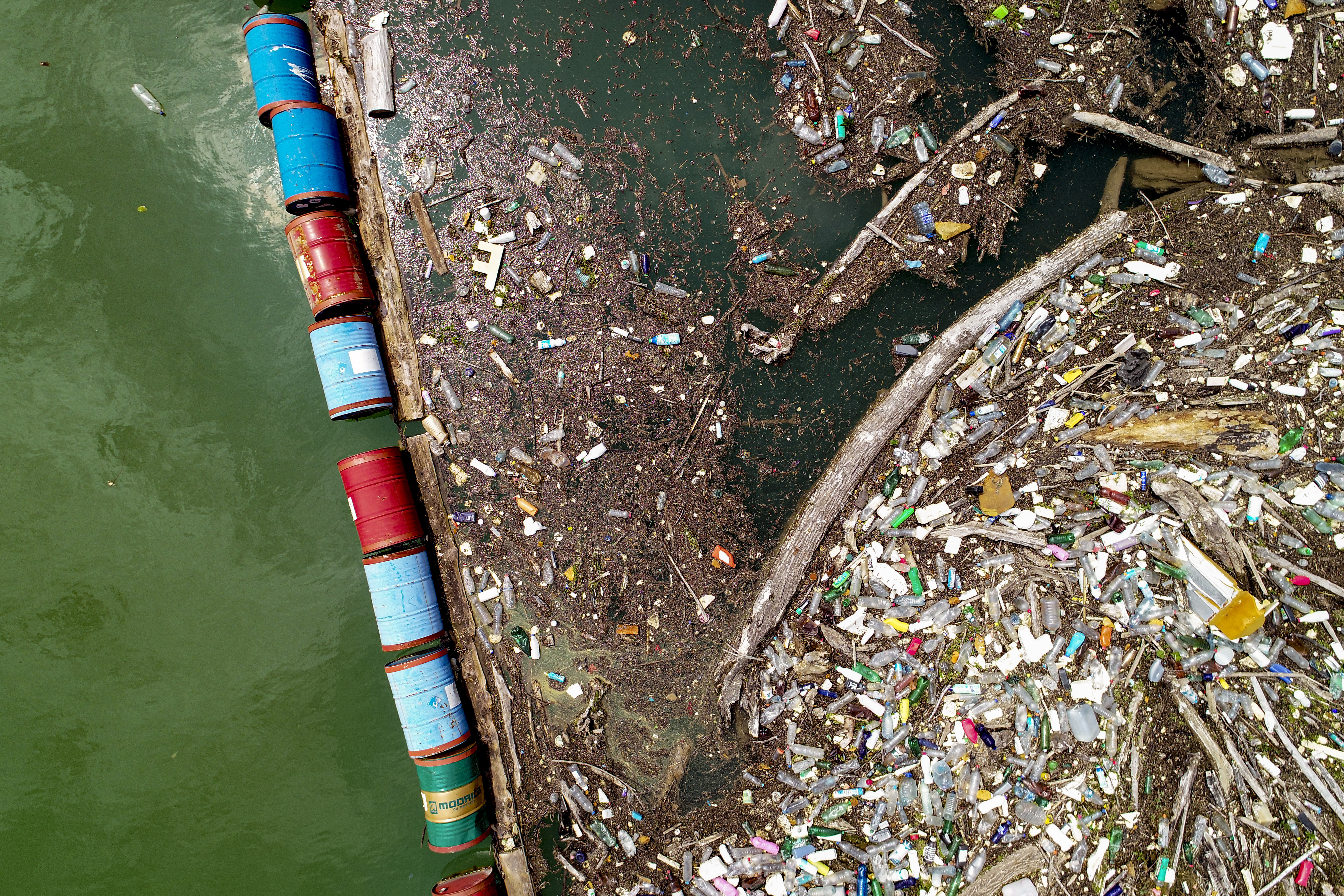 Plastic bottles, wooden planks, rusty barrels and other garbage clog the Drina river near the eastern Bosnian town of Visegrad, Bosnia, Thursday, May 25, 2023. (AP Photo/Eldar Emric)