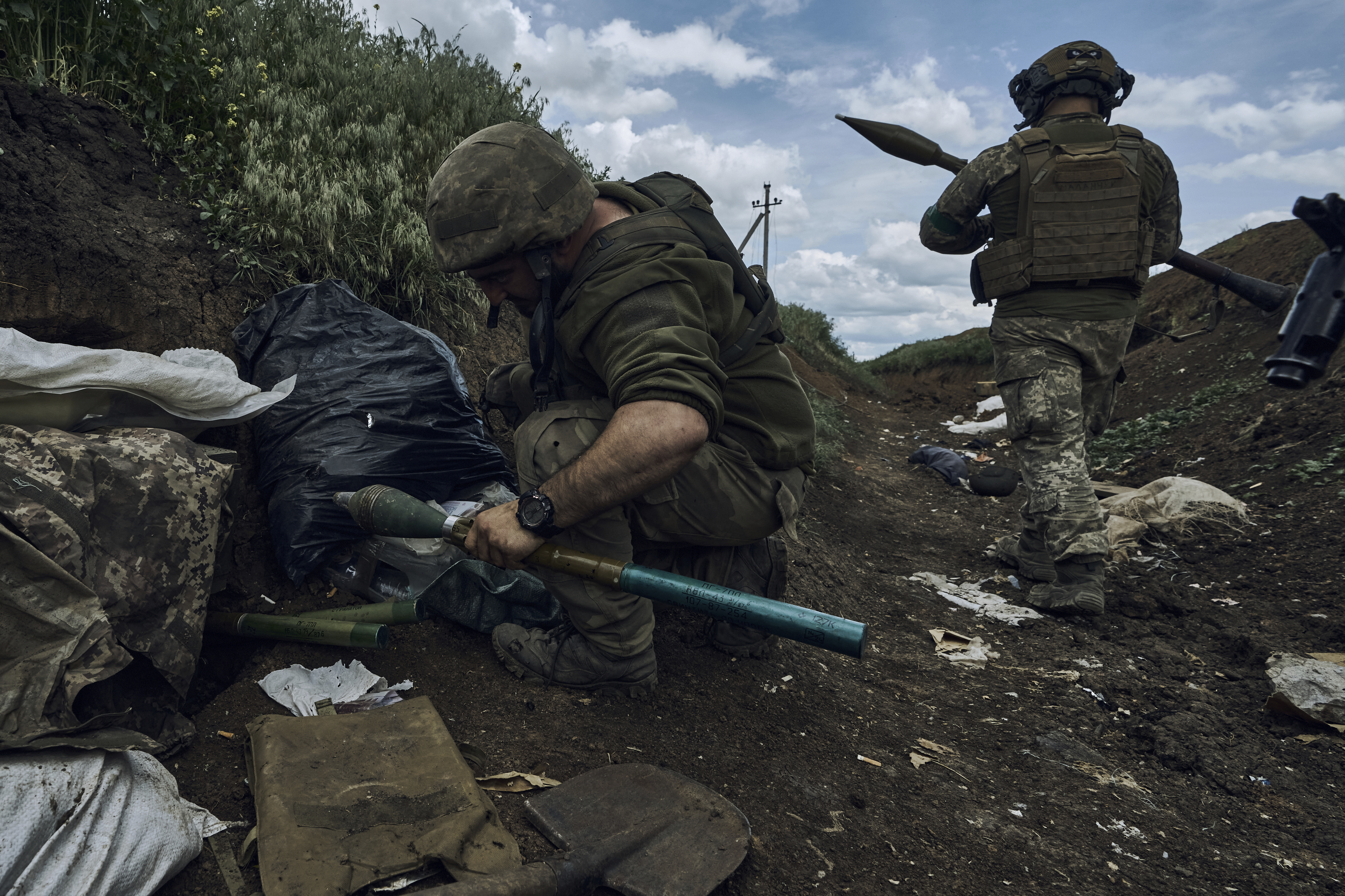 Ukrainian soldiers prepare to fire a rocket-propelled grenade at Russian positions at the front line near Bakhmut in the Donetsk region of Ukraine