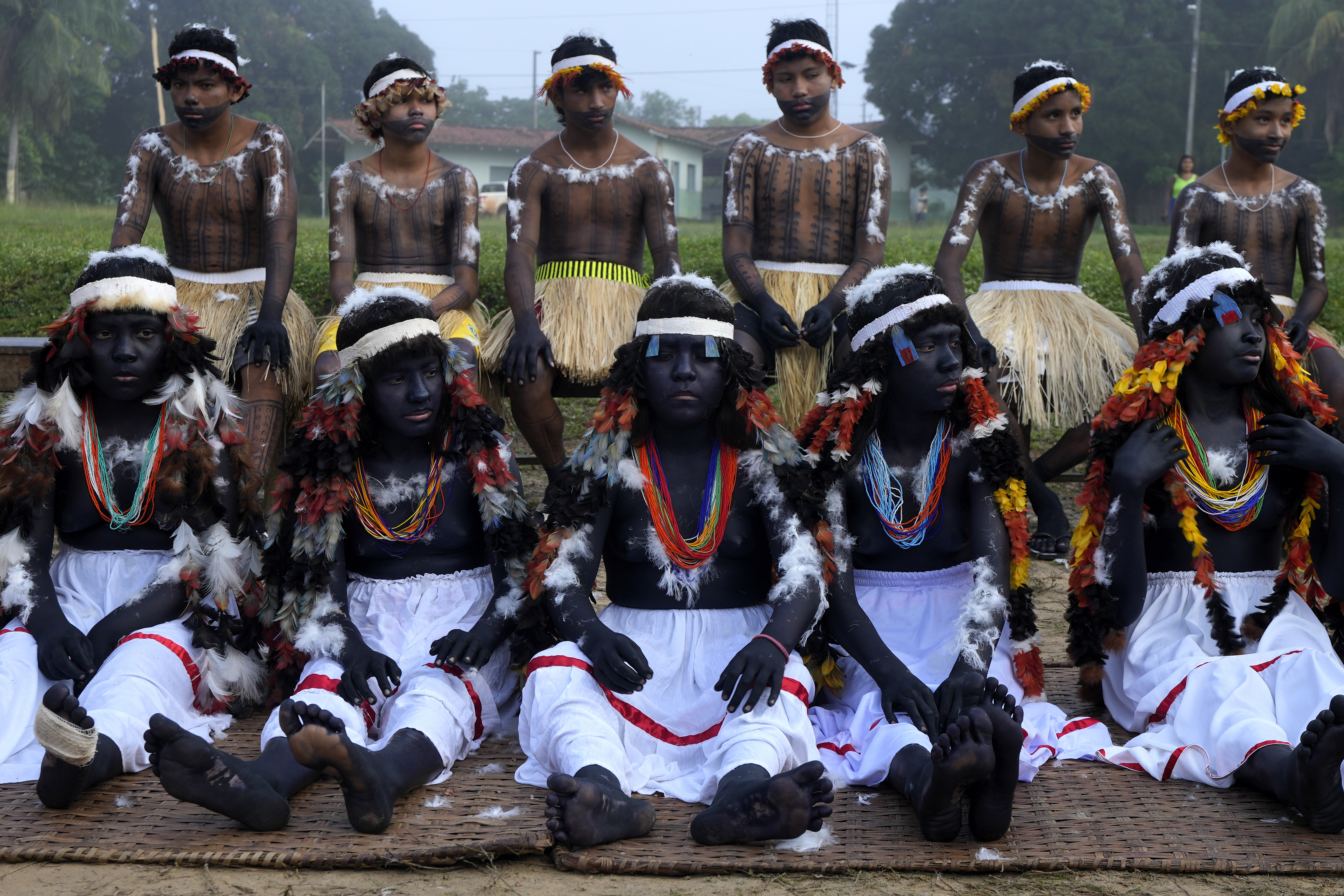 Indigenous girls and boys prepare to take part of a ritual during the final and most symbolic day of the Wyra'whaw coming-of-age festival at the Ramada ritual center, in the Tenetehar Wa Tembe village, located in the Alto Rio Guama Indigenous territory in Para state, Brazil,
