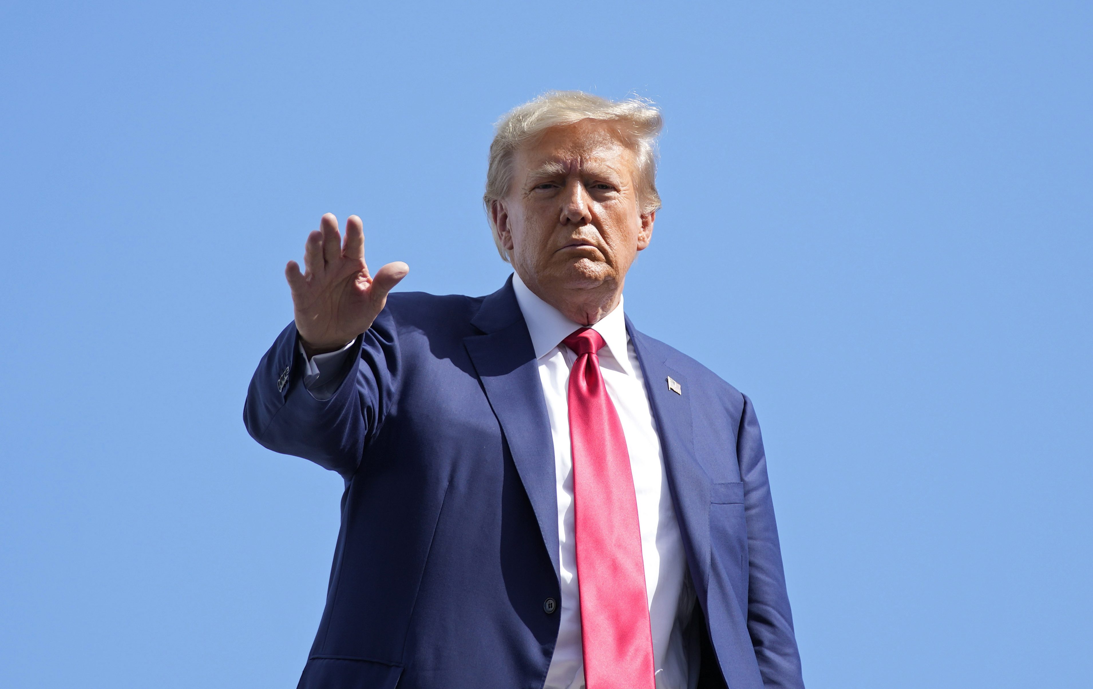 Trump boards his private plane at Miami international airport earlier in June