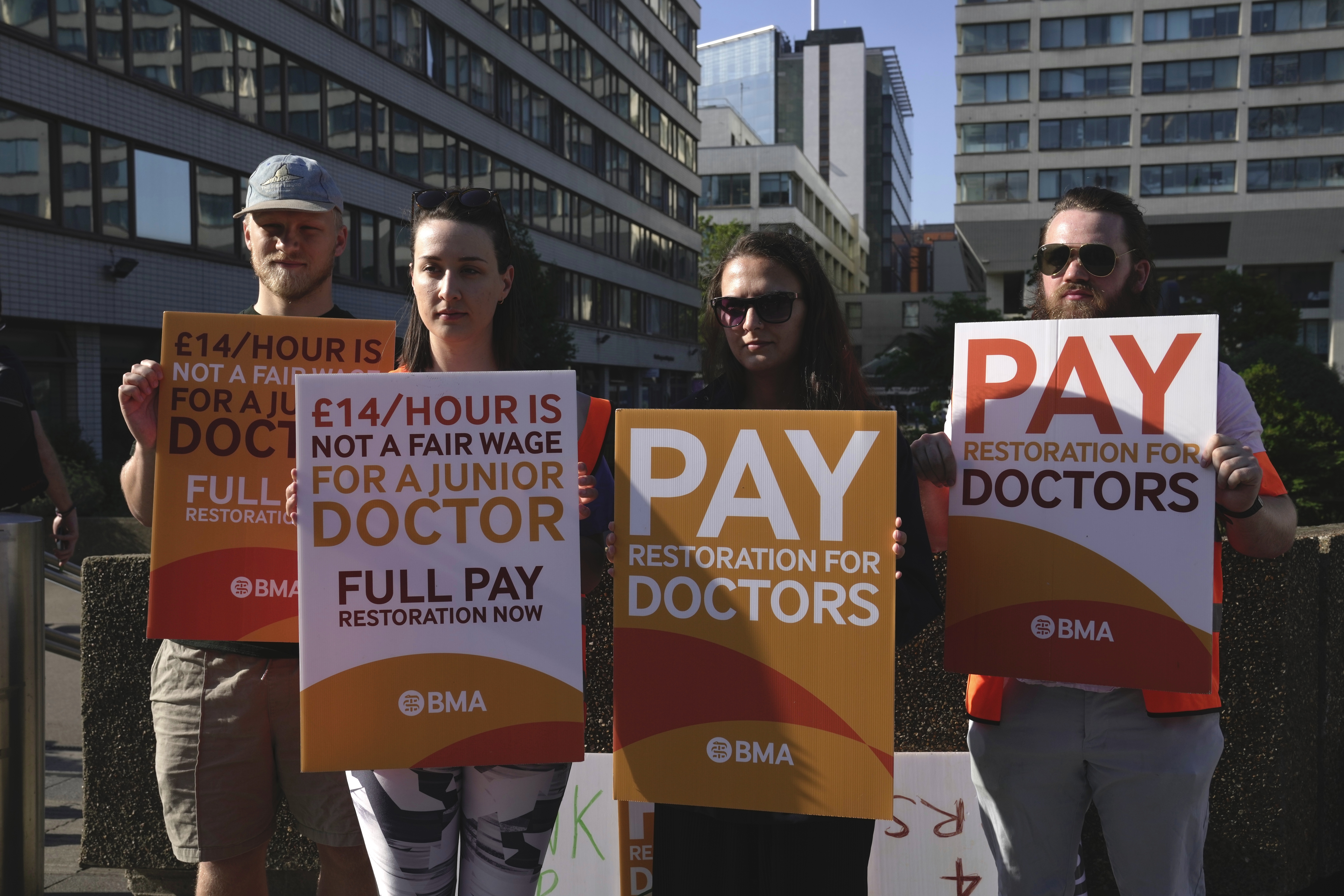 Junior doctors participate in a strike outside the St Thomas' Hospital in London