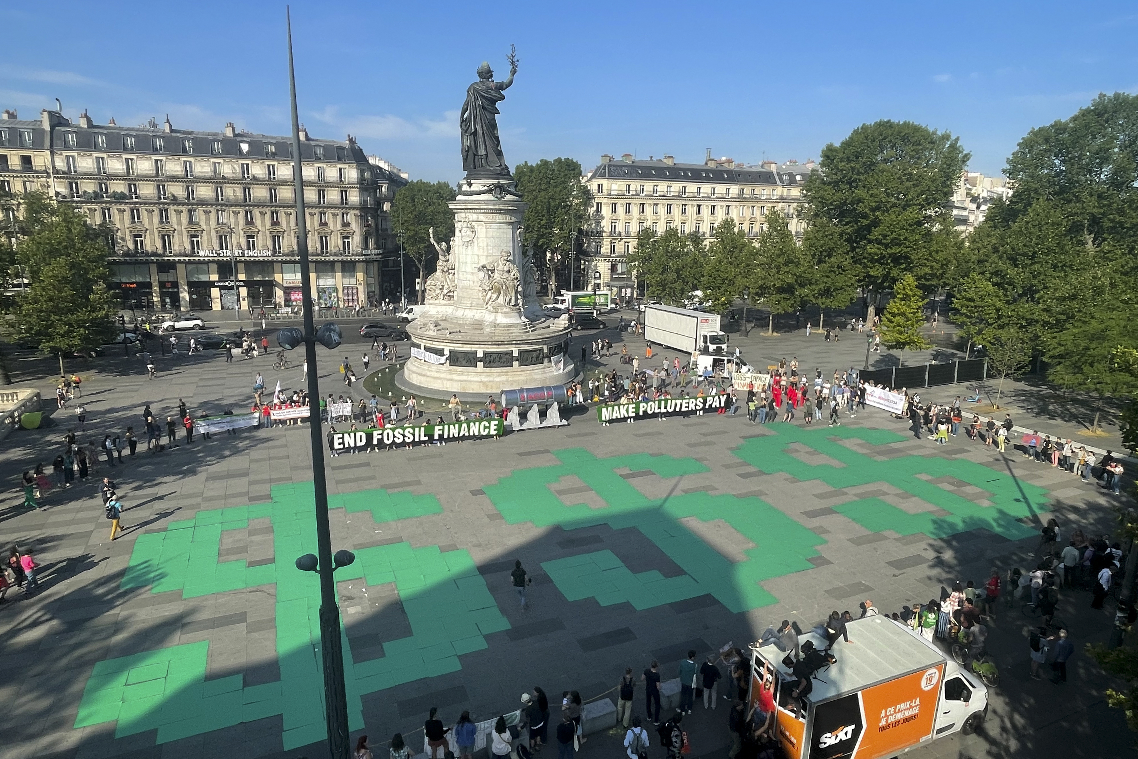 Activists from Avaaz, 350.org, Fridays For Future, Glasgow Actions Team, and more takeover in call for global leaders to end fossil fuel finance in the Place de la Republique on the sidelines of the Global Climate Finance Summit in Paris