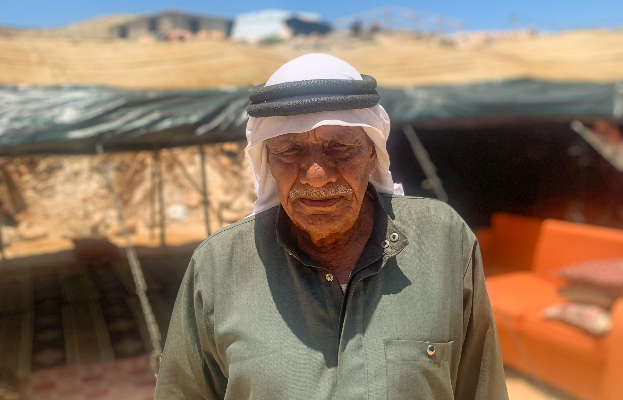 Abu Najjeh, in his traditional headdress and robe, looking defeated