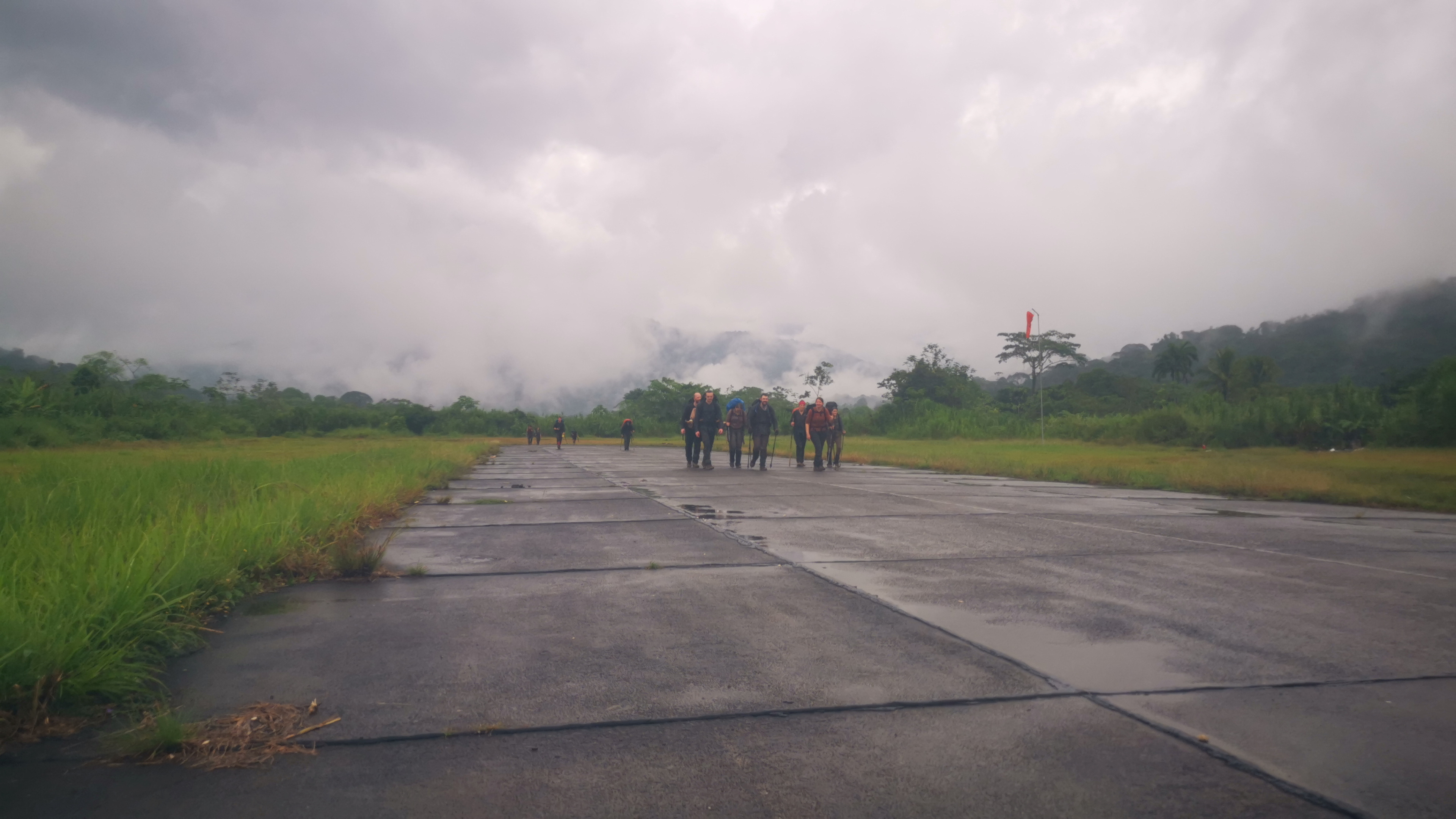 Tourists hike along a runway