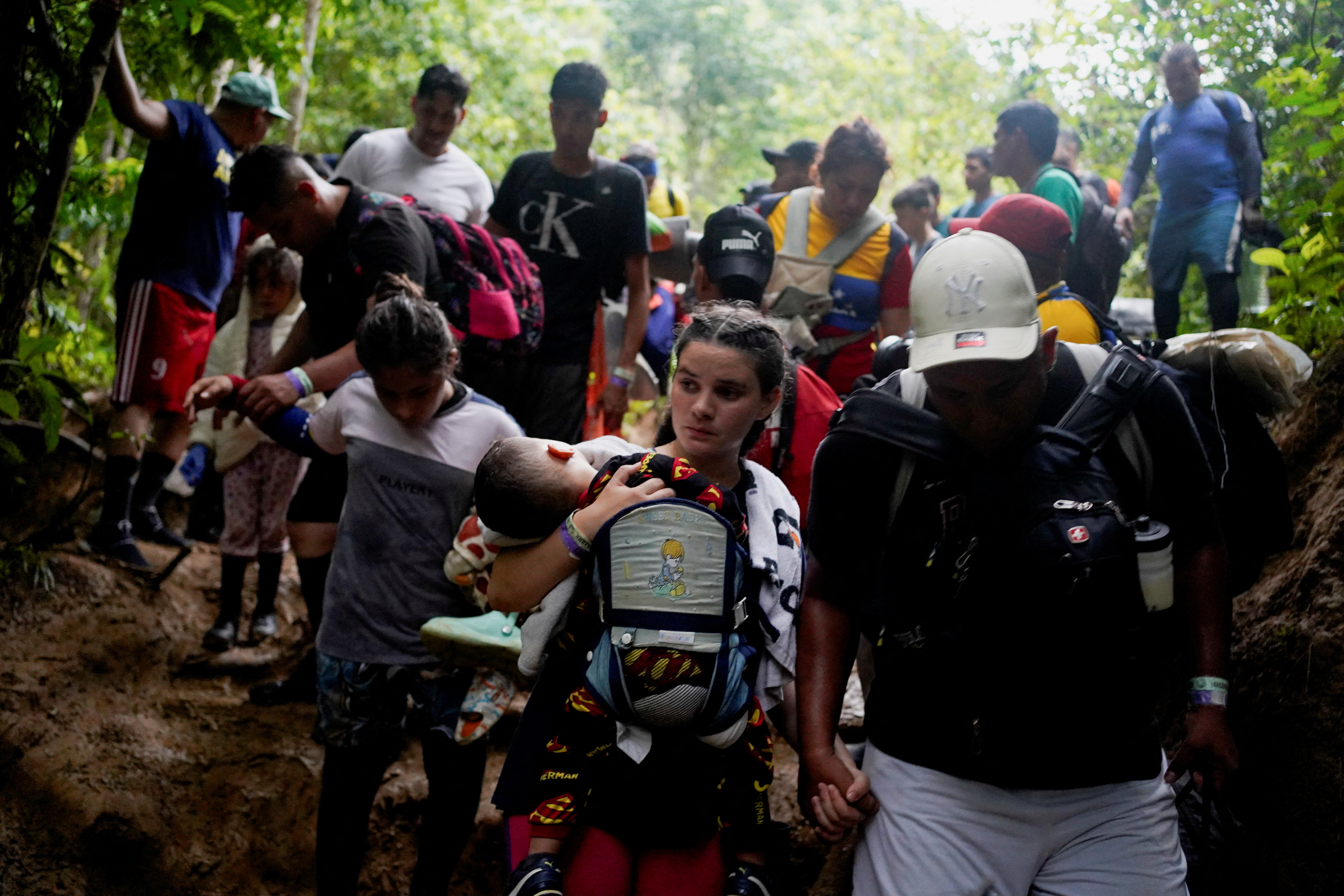 A group of migrants, mostly from Venezuela and Ecuador, walk through the Darien Gap