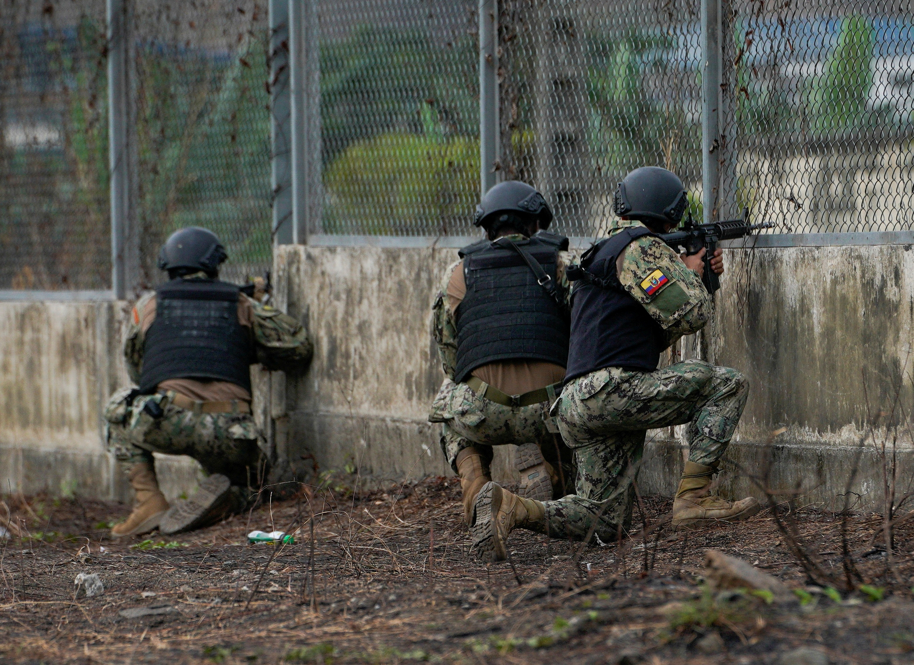 Soldiers guard a gate at a prison in Ecuador in 2022