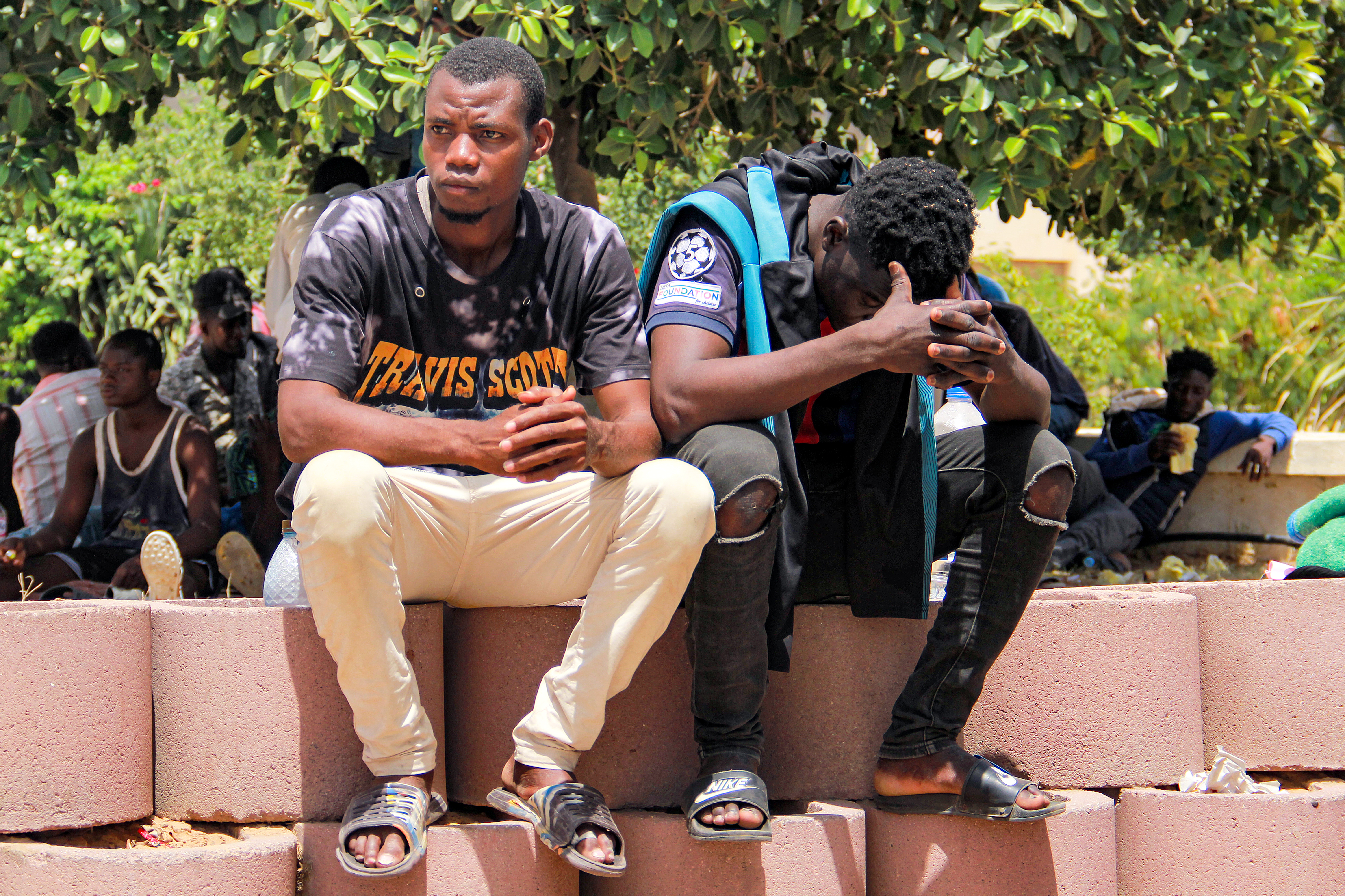 Sub-Saharan migrants attend a protest against the dire conditions of migrants in Tunisia's coastal central city of Sfax on July 7, 2023, after the death of a young Tunisian stabbed in an altercation between locals and migrants. - Hundreds of African migrants were stranded in dire conditions in a desert area of southern Tunisia on July 6 after being expelled from the port city of Sfax, witnesses told AFP. Racial tensions flared this week into violence targeting migrants from sub-Saharan African countries, with dozens fleeing the city or being forcibly evicted. (Photo by HOUSSEM ZOUARI / AFP)