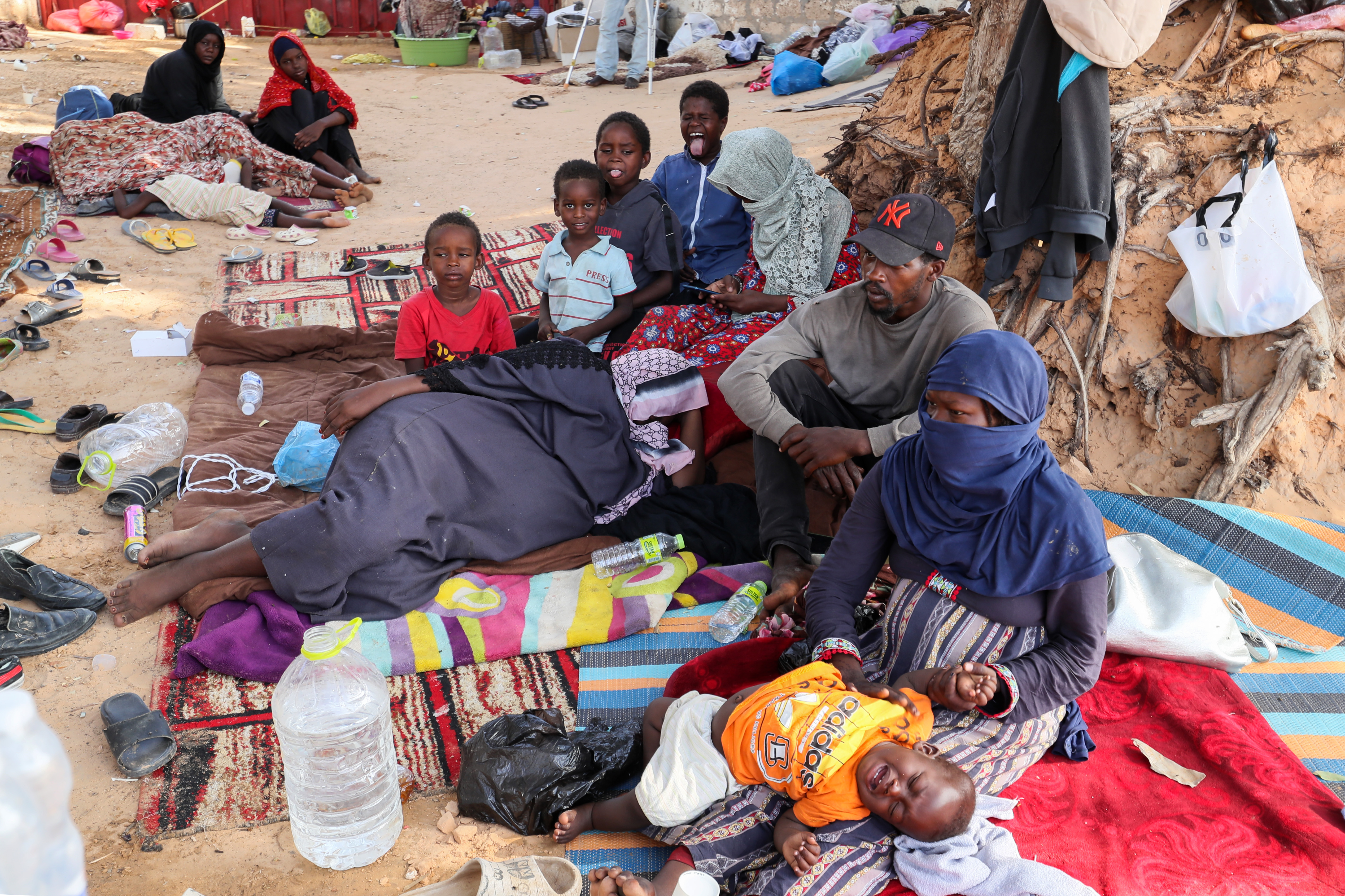 Refugees from war-torn Sudan hold a sit-in seeking support in front of the United Nation High Commissioner for Refugees (UNHCR) offices in Tripoli, on July 15, 2023. - Sudanese army representatives have returned to Jeddah in Saudi Arabia for talks with their paramilitary foes, a government source said on July 15 as the war between rival generals entered its fourth month. (Photo by Mahmud Turkia / AFP)