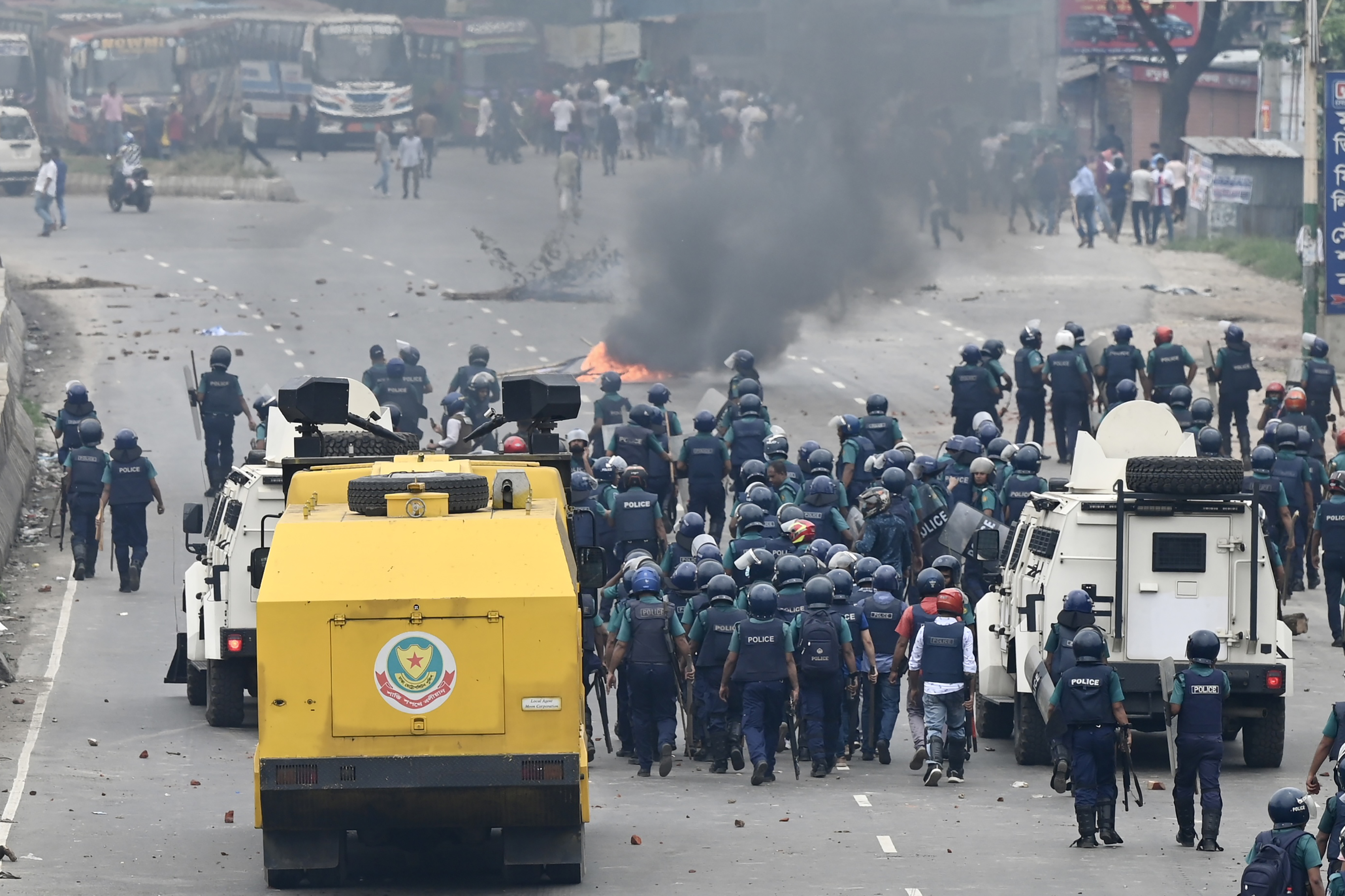 Police moves towards Bangladesh Nationalist party (BNP) activists (top) blocking a highway entering Bangladesh's capital protesting to demand the resignation of Prime Minister Sheikh Hasina and a general election under a neutral caretaker government, in Dhaka on July 29, 2023
