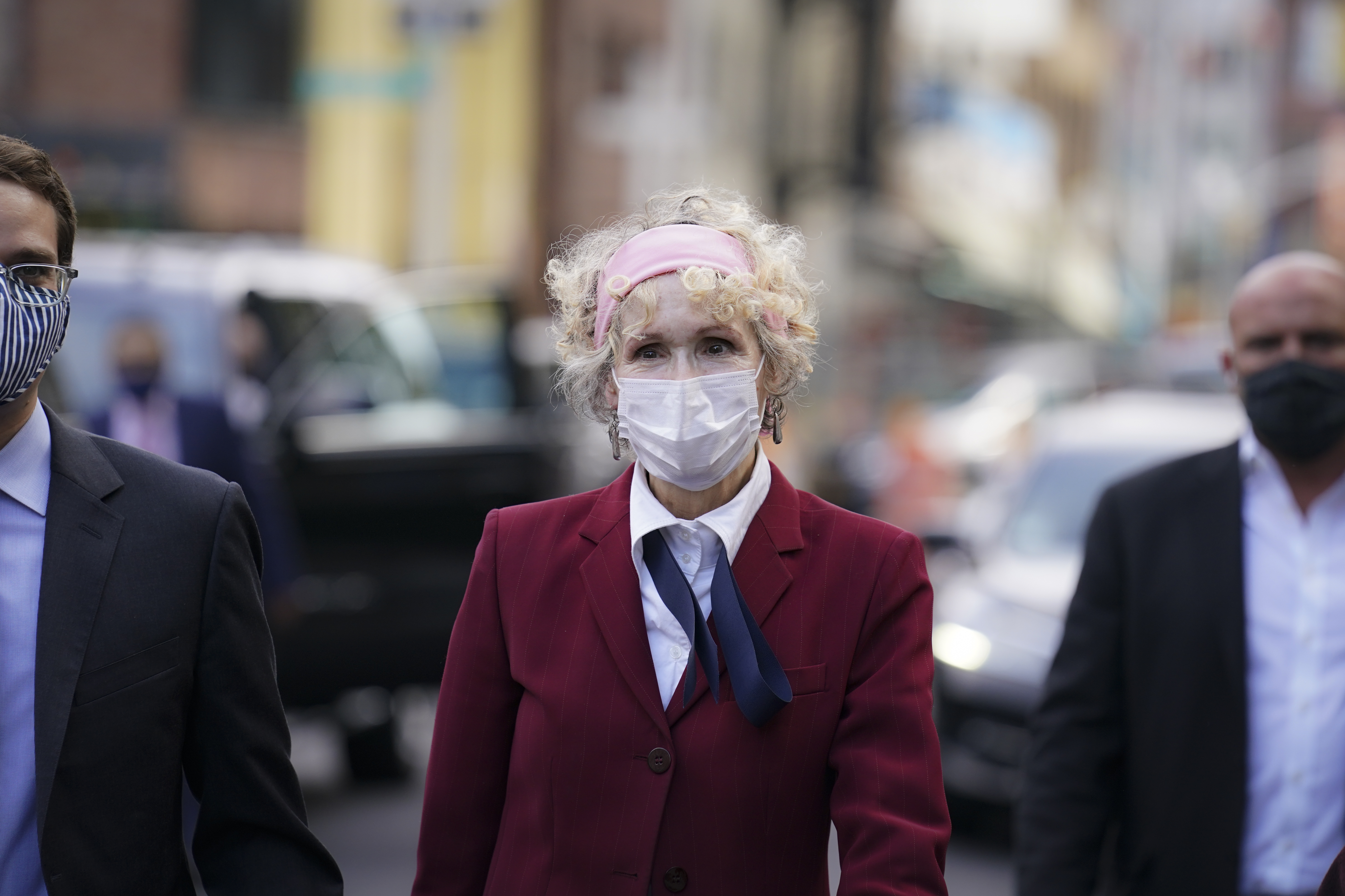 A woman in a red blazer walks to the Daniel Patrick Moynihan United States Courthouse, Wednesday, Oct. 21, 2020, in New York.