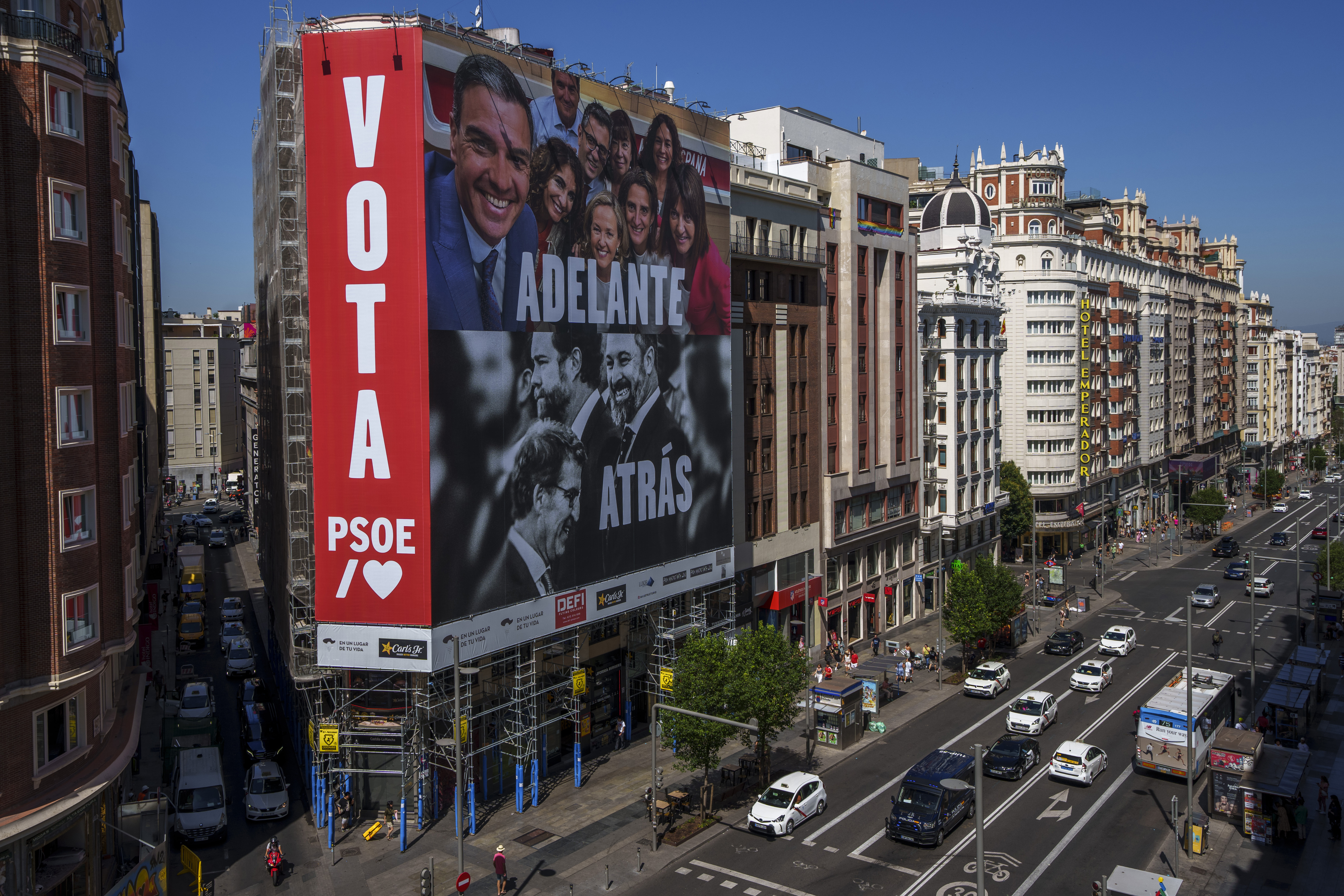 A giant electoral poster depicting Spanish Prime minister and PSOE candidate Pedro Sanchez, top, and conservative PP party leader Alberto Nunez Feijoo and VOX far right party leader Santiago Abascal hangs from a building at the Gran Via avenue in Madrid