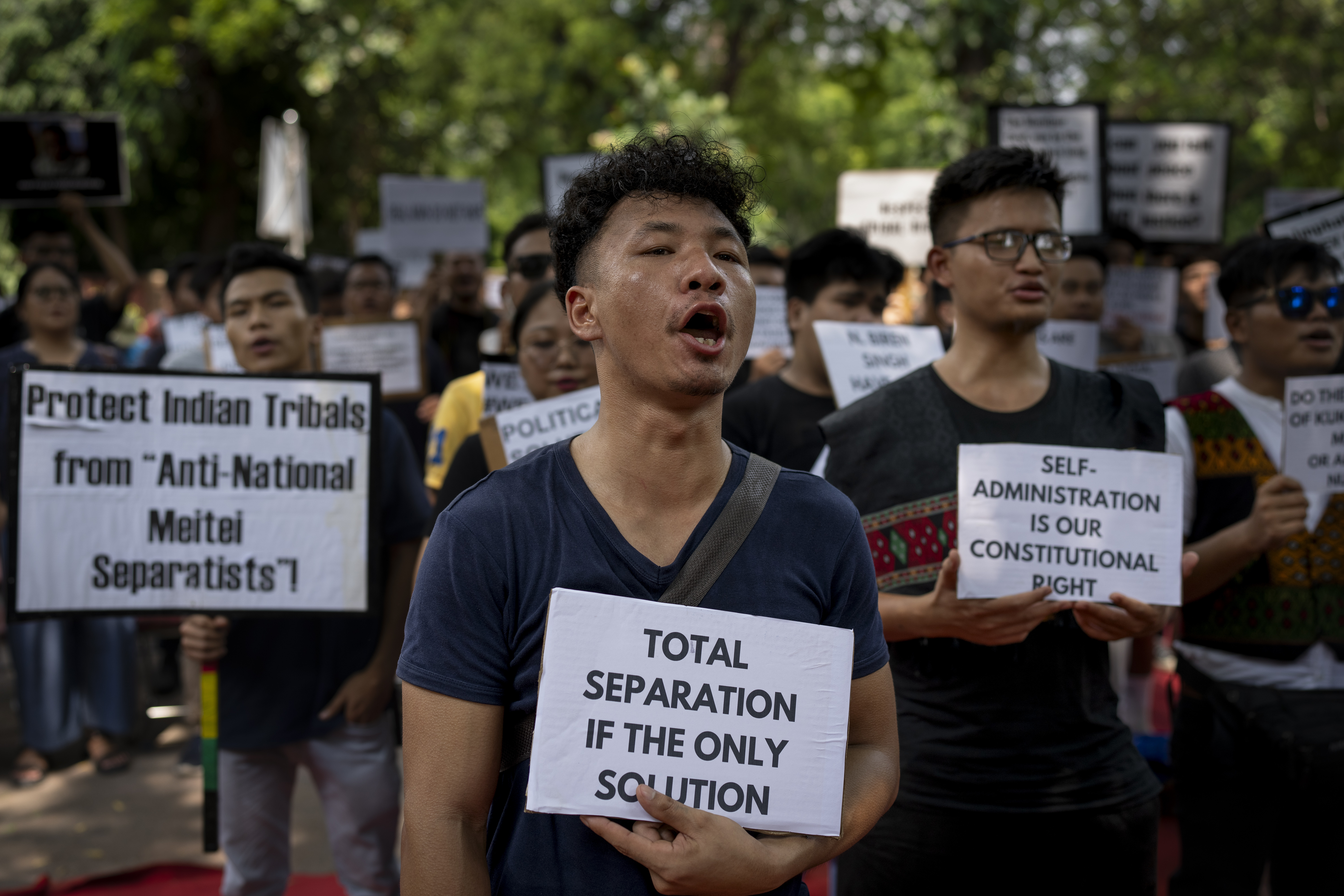 Kuki tribal protestors shout slogans during a demonstration in New Delhi