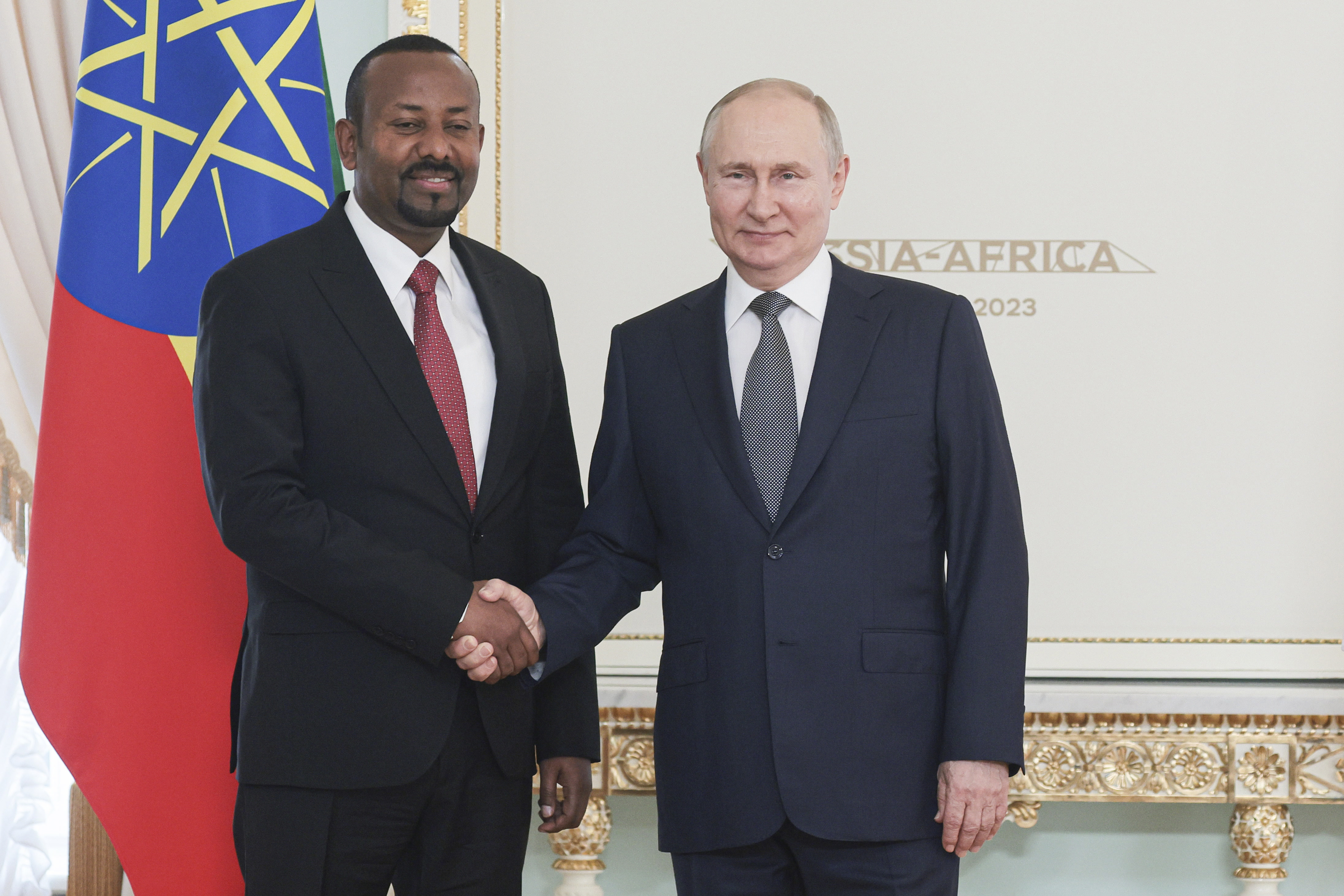 Russian President Vladimir Putin, right, and Ethiopian Prime Minister Abiy Ahmed shake hands during their meeting on the eve of the Russia Africa Summit in St. Petersburg, Russia, Wednesday, July 26, 2023. (TASS News Agency Host Pool Photo via AP, File)